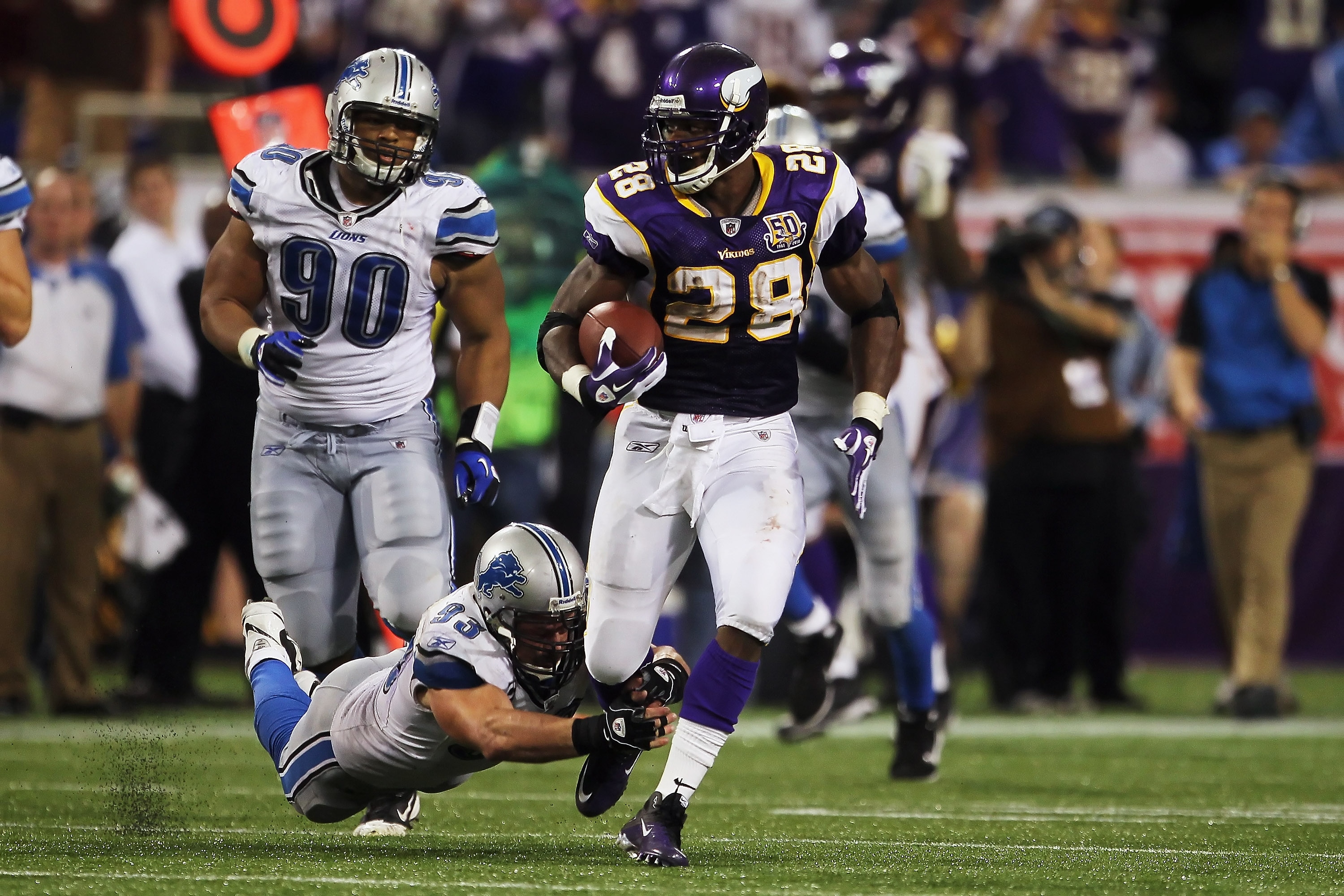 MINNEAPOLIS - SEPTEMBER 26:  Running back Adrian Peterson #28 of the Minnesota Vikings breaks a tackle from Kyle Vanden Bosch #93 of the Detroit Lions at Mall of America Field on September 26, 2010 in Minneapolis, Minnesota. The Vikings defeated the Lions