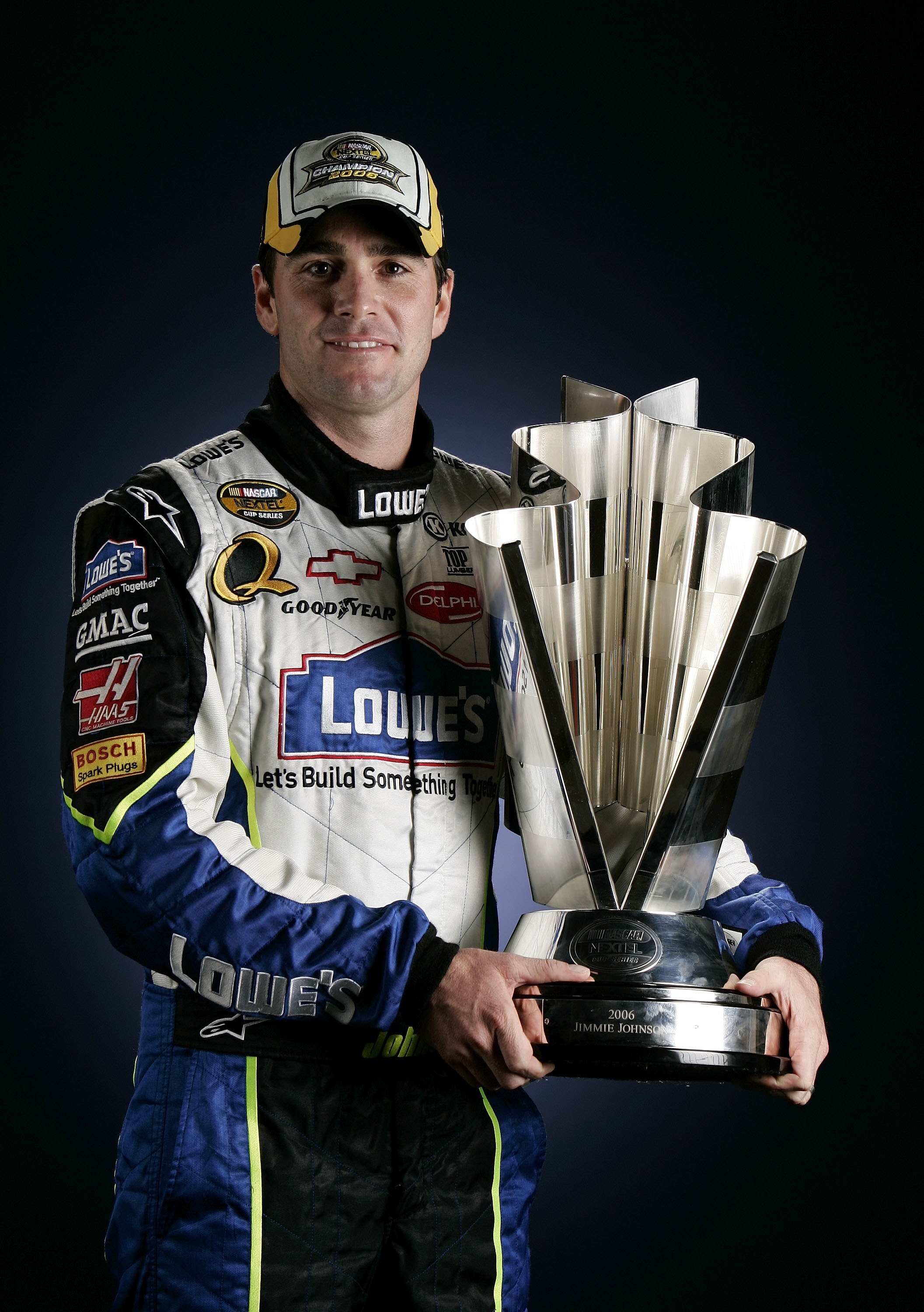 HOMESTEAD, FL - NOVEMBER 19:  2006 NASCAR Nextel Cup Series Champion Jimmie Johnson, driver of the #48 Lowe's Chevrolet, poses with the Nextel Cup, following the NASCAR Nextel Cup Series Ford 400, on November 19, 2006 at Homestead-Miami Superspeedway  in