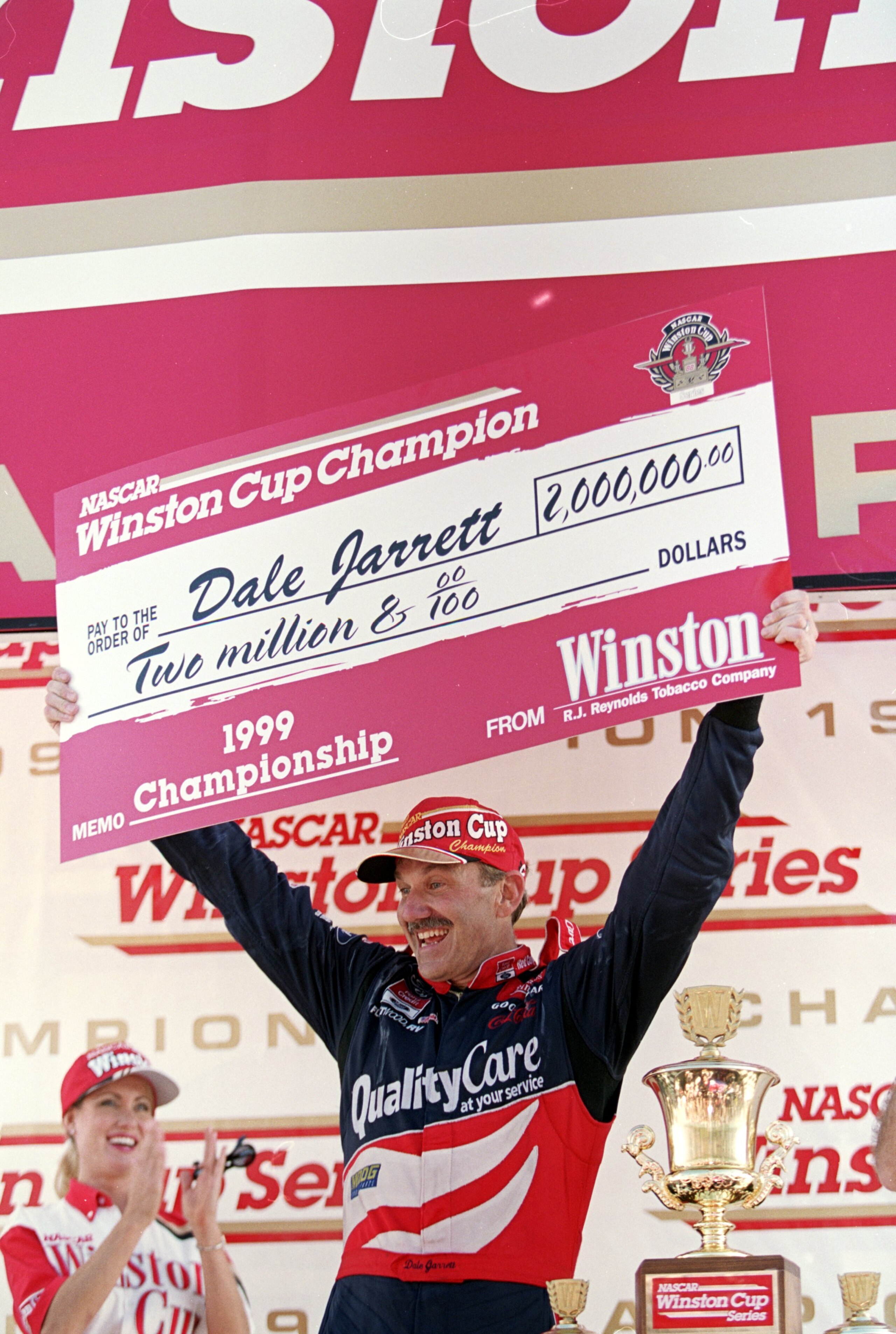 14 Nov 1999:  Dale Jarrett smiles and holds up his check after winning  the Pennzoil 400, part of the NASCAR Winston Cup Series, at the Homestead - Miami Speedway in Homestead, Florida. Mandatory Credit: Jon Ferrey  /Allsport