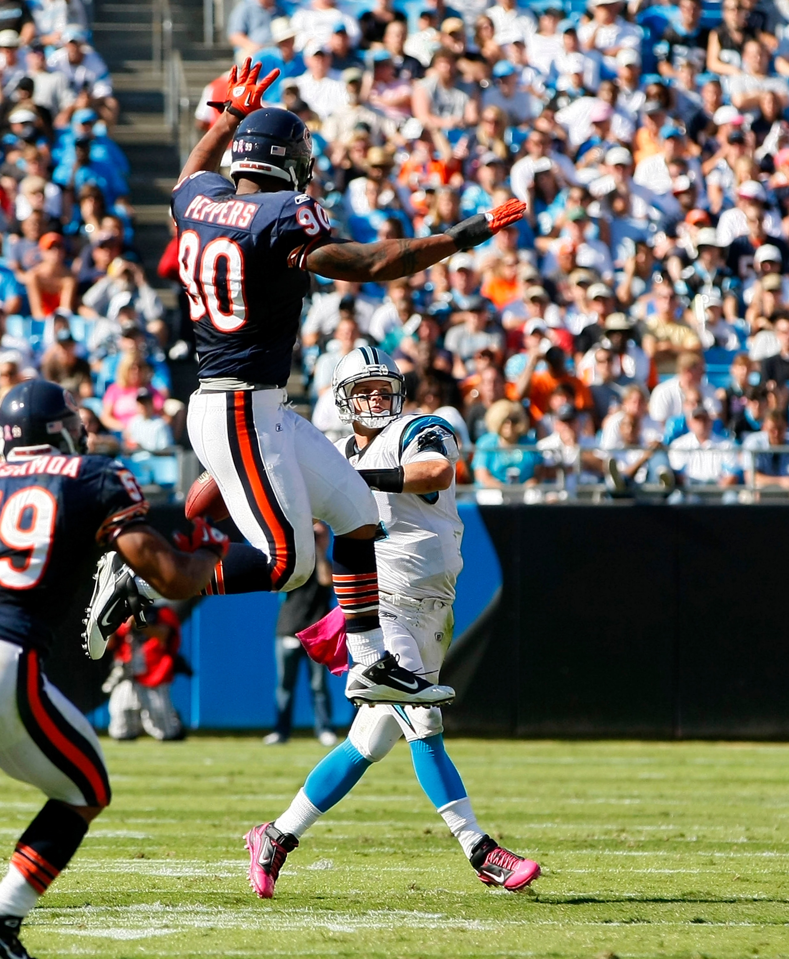 CHARLOTTE, NC - OCTOBER 10: Quarterback Jimmy Clausen #2 of the Carolina Panthers throws the ball over defensive end Julius Peppers #90 of the Chicago Bears at Bank of America Stadium on October 10, 2010 in Charlotte, North Carolina. (Photo by Geoff Burke