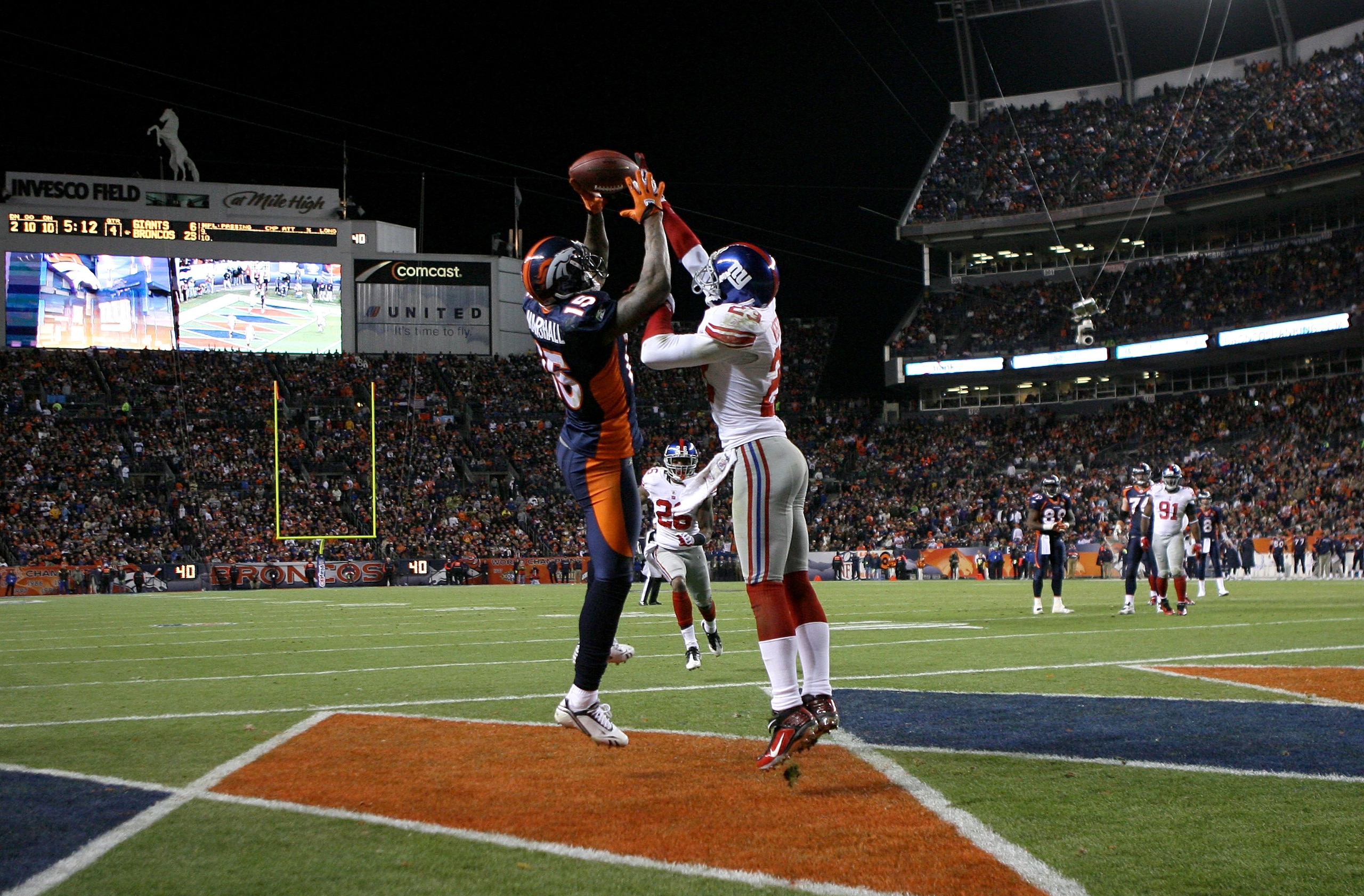DENVER - NOVEMBER 26:  Corey Webster #23 of the New York Giants breaks up a pass in the endzone intended for wide receiver Brandon Marshall #15 of the Denver Broncos during NFL action at Invesco Field at Mile High on November 26, 2009 in Denver, Colorado.