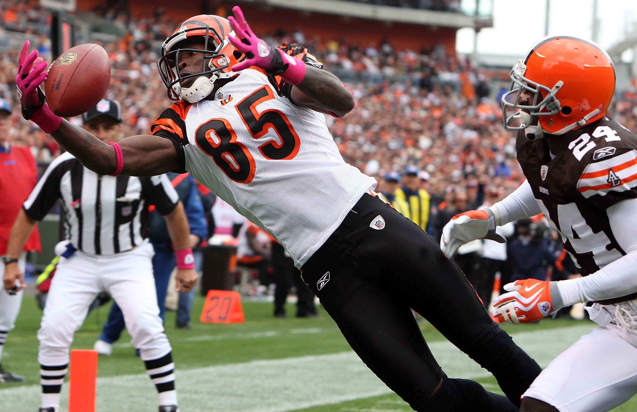 CLEVELAND - OCTOBER 04:  Chad Ochocinco #85 of the Cincinnati Bengals hauls in a one handed catch for a first quatrer touchdown against Eric Wright #24 of the Cleveland Browns during their game at Cleveland Browns Stadium on October 4, 2009 in Cleveland,