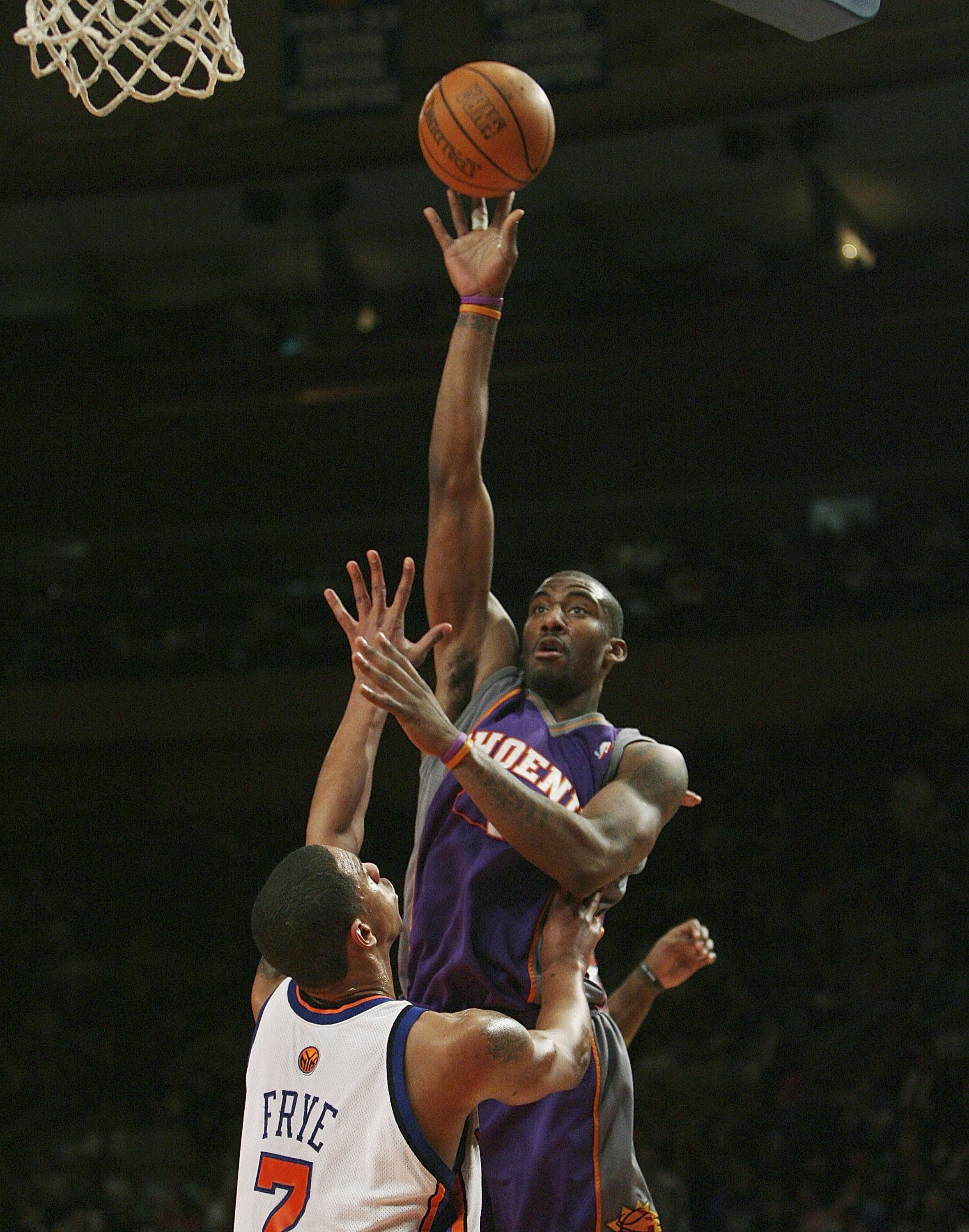 NEW YORK - JANUARY 24:  Amare Stoudemire #1 of the Phoenix Suns shoots over Channing Frye #7 of the New York Knicks January 24, 2007 at Madison Square Garden in New York City. NOTE TO USER: User expressly acknowledges and agrees that, by downloading and o