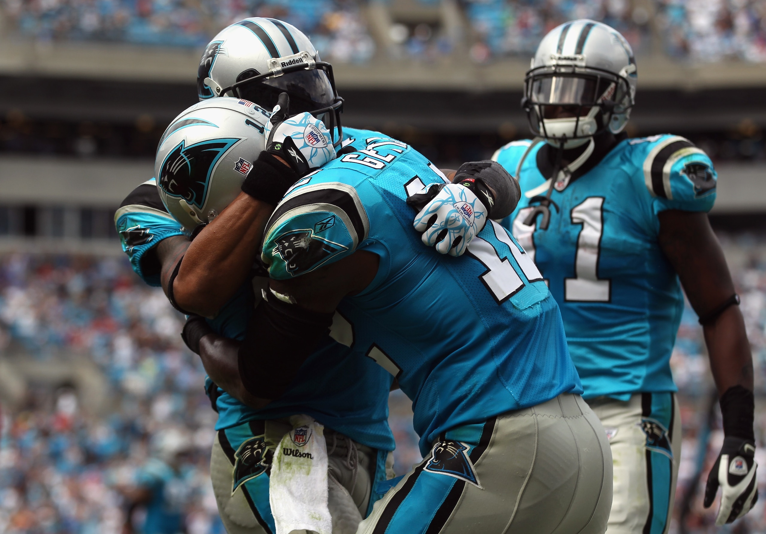 CHARLOTTE, NC - OCTOBER 24:  Teammates Steve Smith #89 and David Gettis #12 of the Carolina Panthers celebrate after Gettis scored a touchdown late in the fourth quarter against the San Francisco 49ers during their game at Bank of America Stadium on Octob