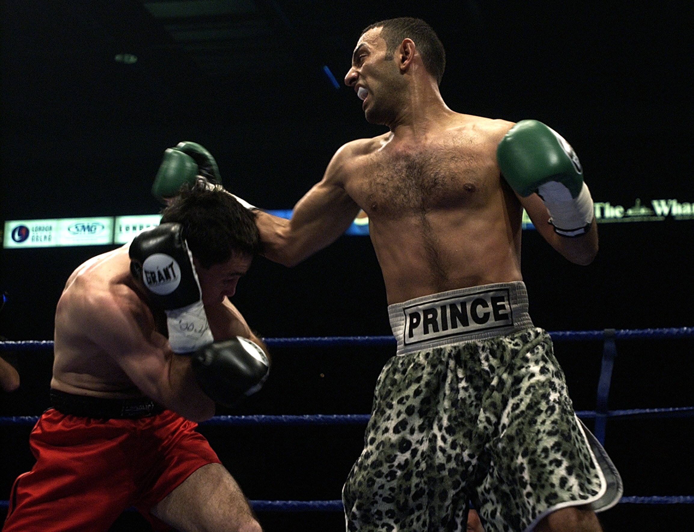 LONDON - May 18:  Prince Naseem Hamed (R) wins the IBO world featherweight title against Manuel Calvo at the London Arena in England on May 18, 2002. DIGITAL IMAGE (Photo by John Gichigi/Getty Images)