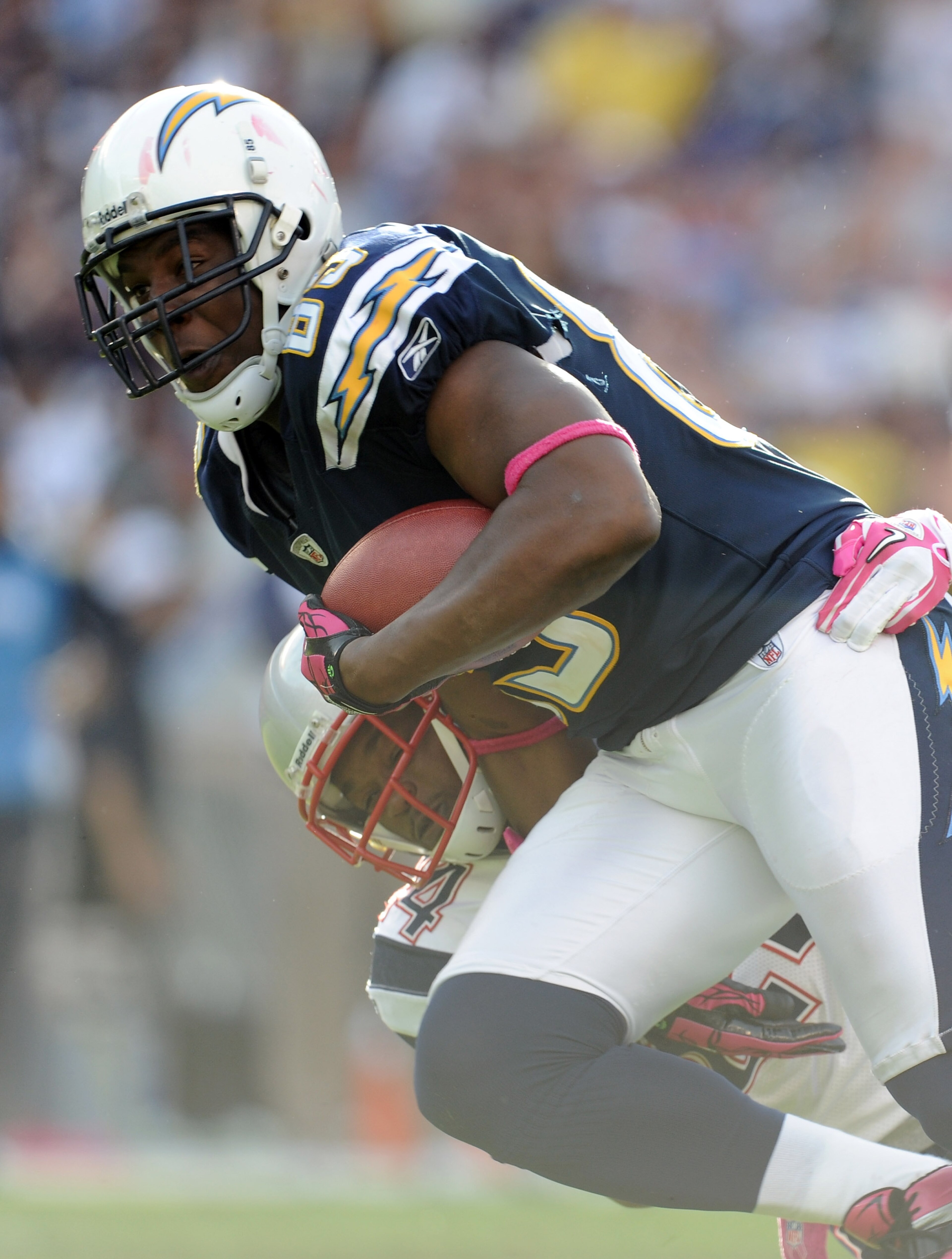 SAN DIEGO - OCTOBER 24:  Antonio Gates #85 of the San Diego Chargers drags Jonathan Wilhite #24 of the New England Patriots after his catch during the fourth quarter at Qualcomm Stadium on October 24, 2010 in San Diego, California.  The Patroits won 23-20