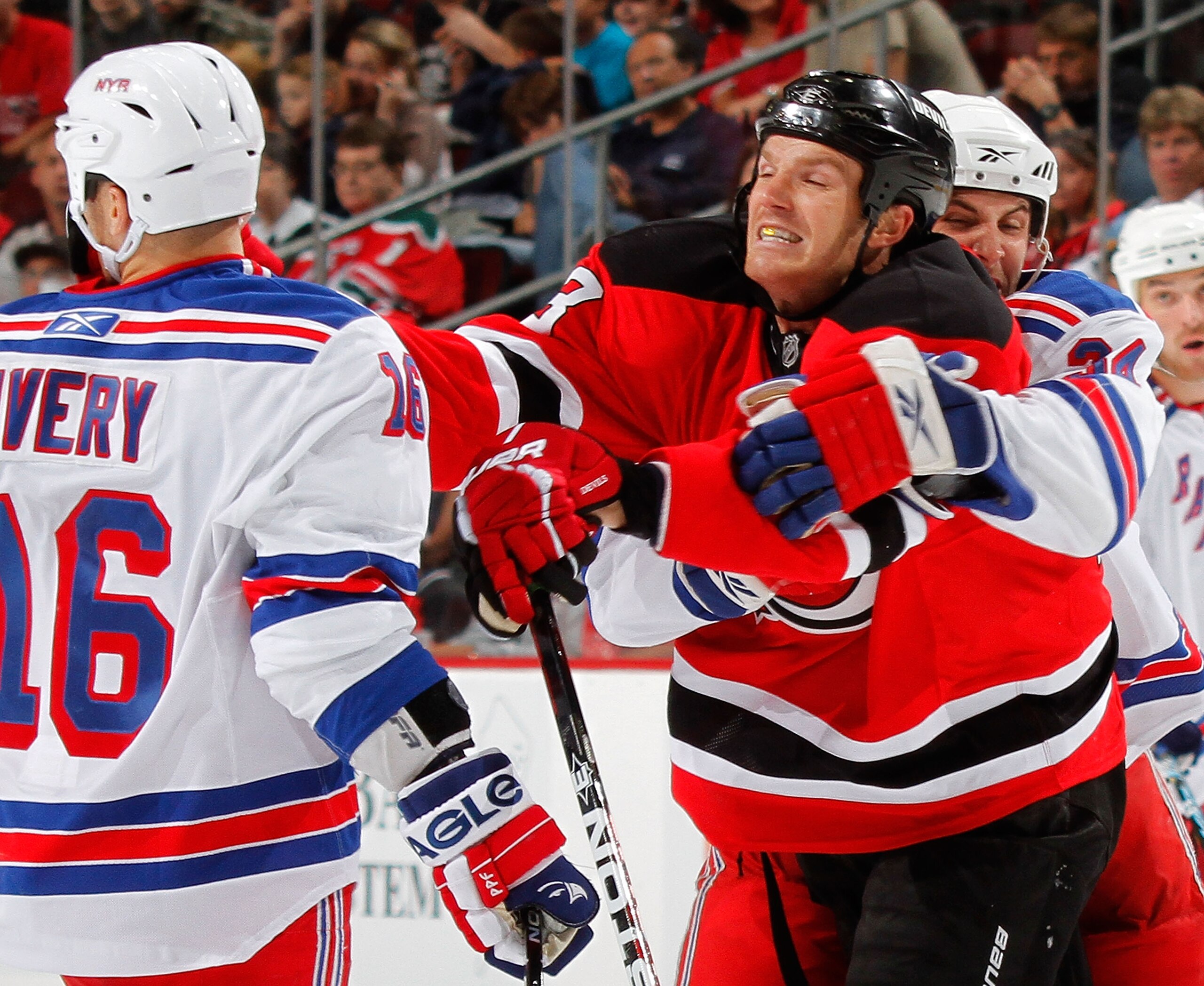 NEWARK, NJ - SEPTEMBER 25: Sean Avery #6 of the New York Rangers gets lunged at by David Clarkson of the New Jersey Devils during a fight in a preseason hockey game at the Prudential Center on September 25, 2010 in Newark, New Jersey.  (Photo by Paul Bere