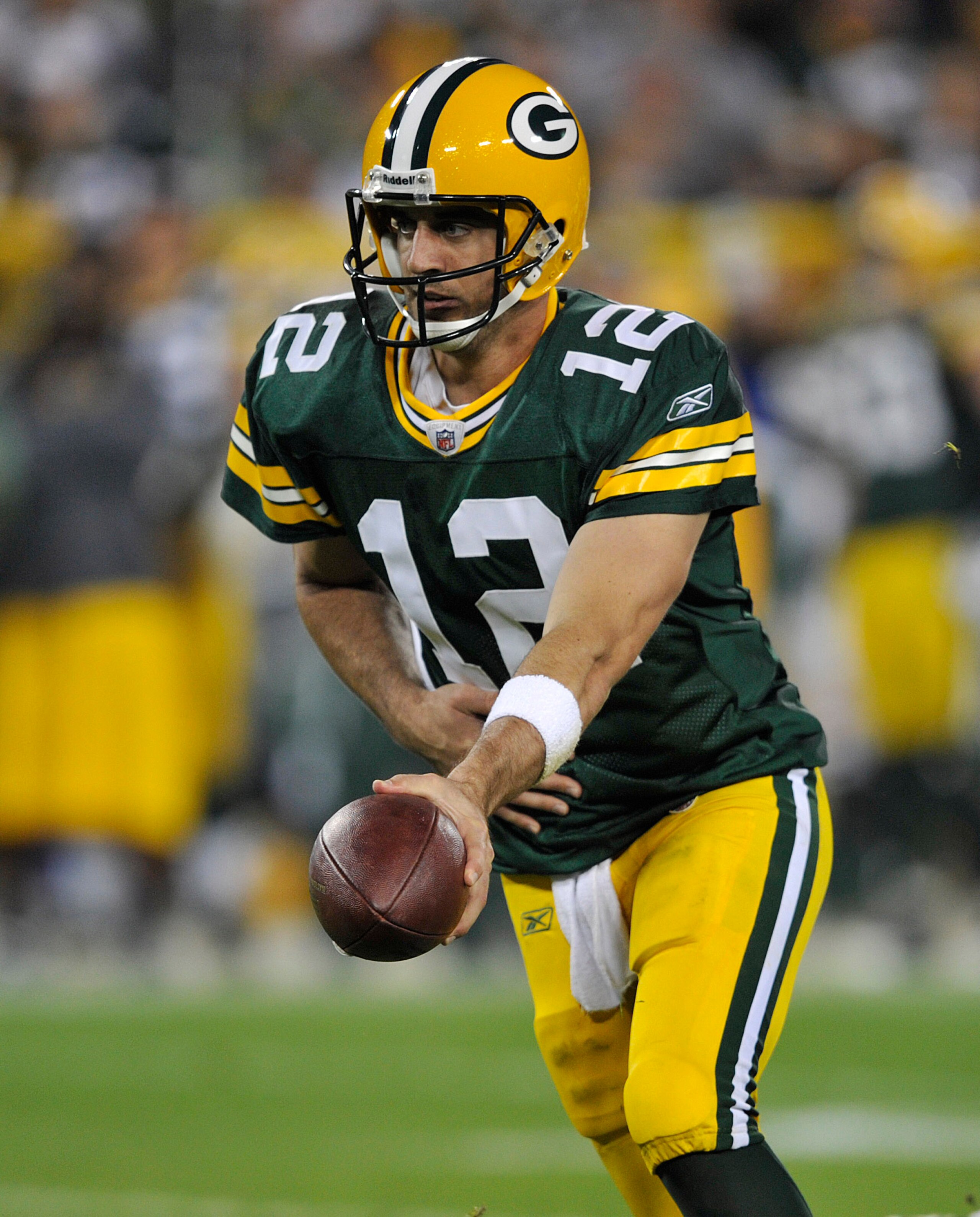 GREEN BAY, WI - OCTOBER 24:  Aaron Rodgers #12 of the Green Bay Packers hands off during their game against the Minnesota Vikings at Lambeau Field on October 24, 2010 in Green Bay, Wisconsin. (Photo by Jim Prisching/Getty Images)