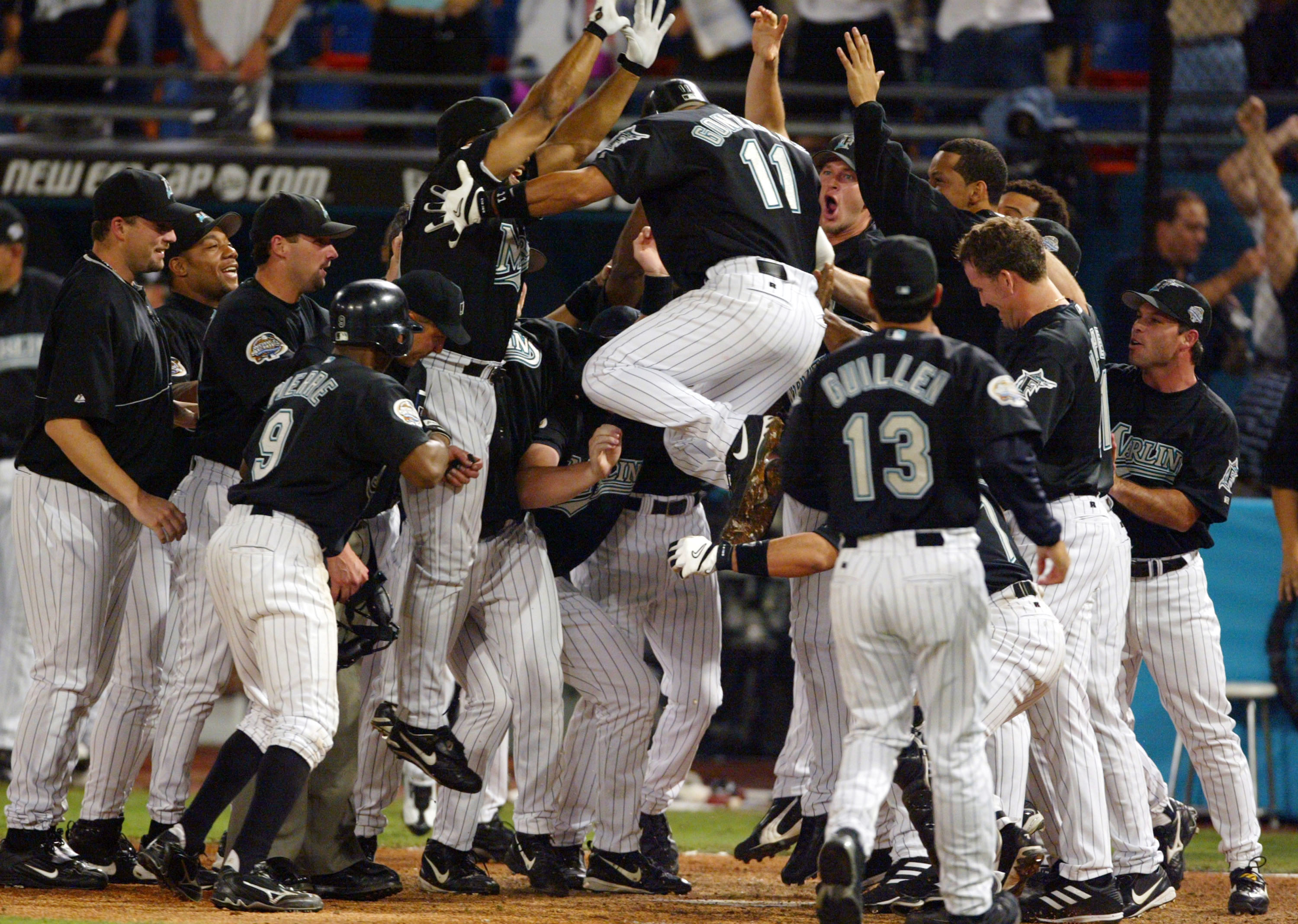 MIAMI - OCTOBER 22:  Alex Gonzalez #11 of the Florida Marlins celebrates with teammates after hitting a game winning solo home run in the 12th innig during game four of the Major League Baseball World Series against the New York Yankees on October 22, 200