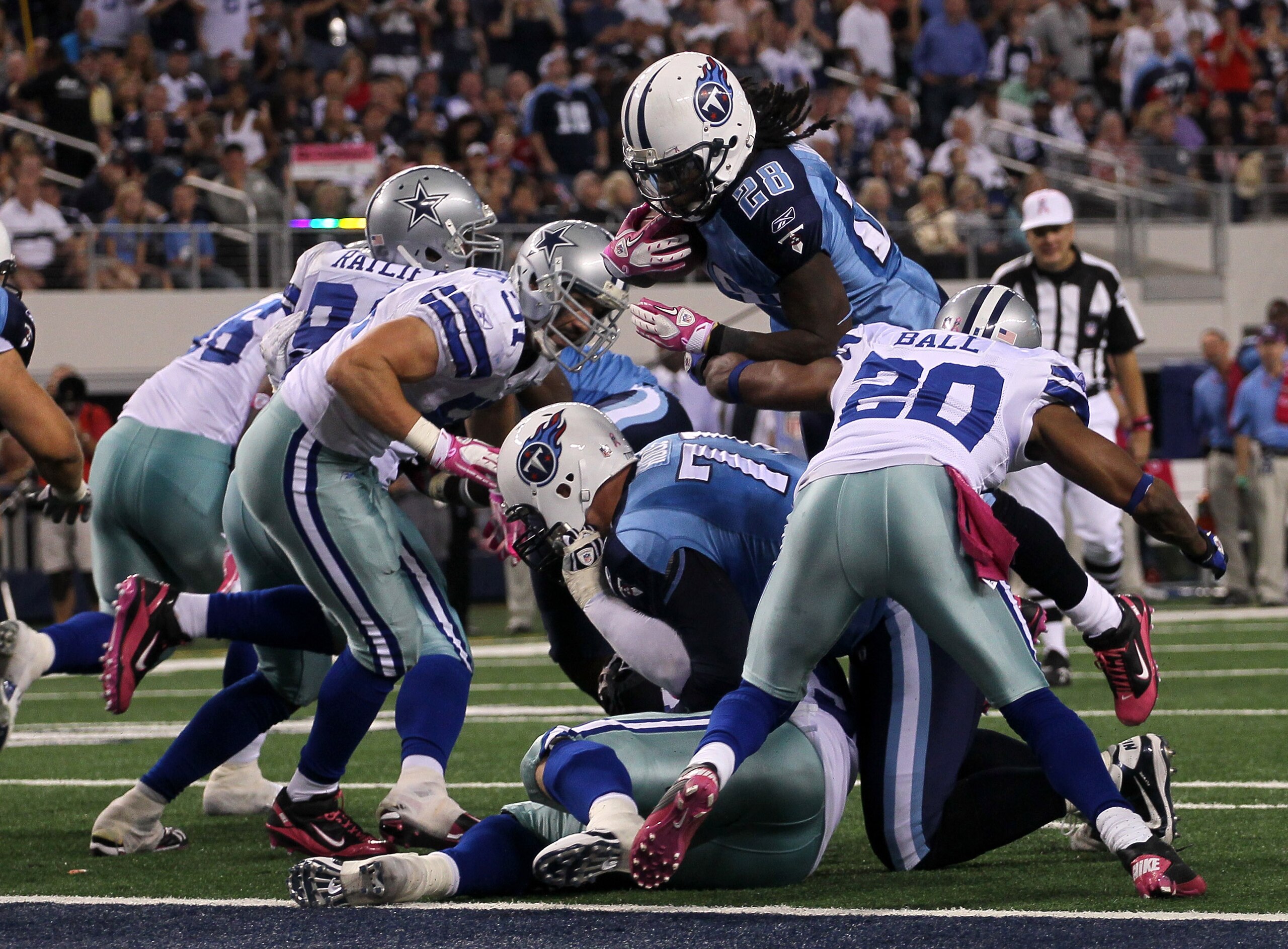 ARLINGTON, TX - OCTOBER 10:  Running back Chris Johnson #28 of the Tennessee Titans dives over the line to score the winning touchdown in the fourth quarter against the Dallas Cowboys at Cowboys Stadium on October 10, 2010 in Arlington, Texas.   The Titan