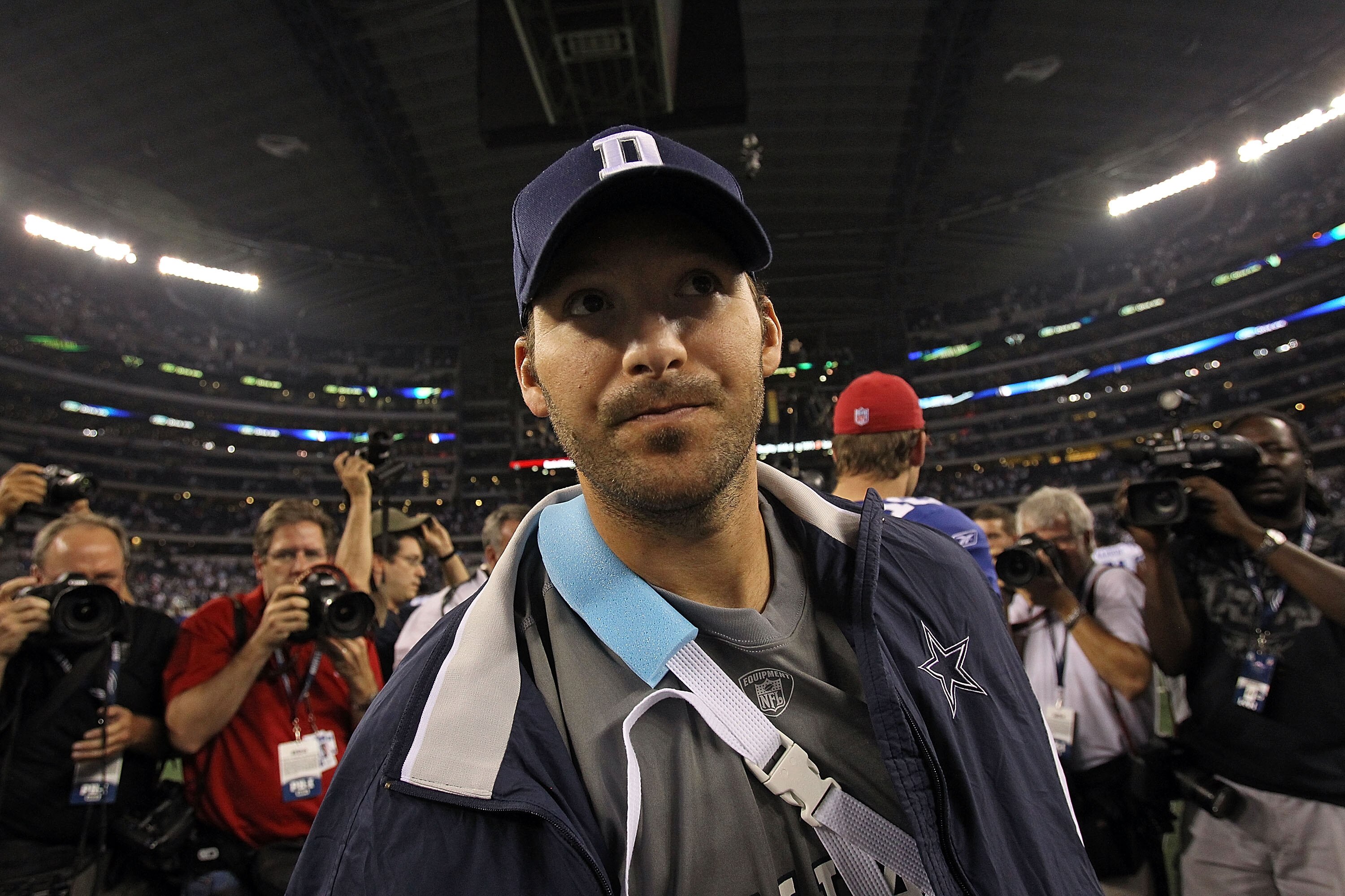 ARLINGTON, TX - OCTOBER 25:  Quarterback Tony Romo #9 of the Dallas Cowboys walks off the field wearing an arm sling after a 41-35 loss against the New York Giants at Cowboys Stadium on October 25, 2010 in Arlington, Texas.  (Photo by Ronald Martinez/Gett