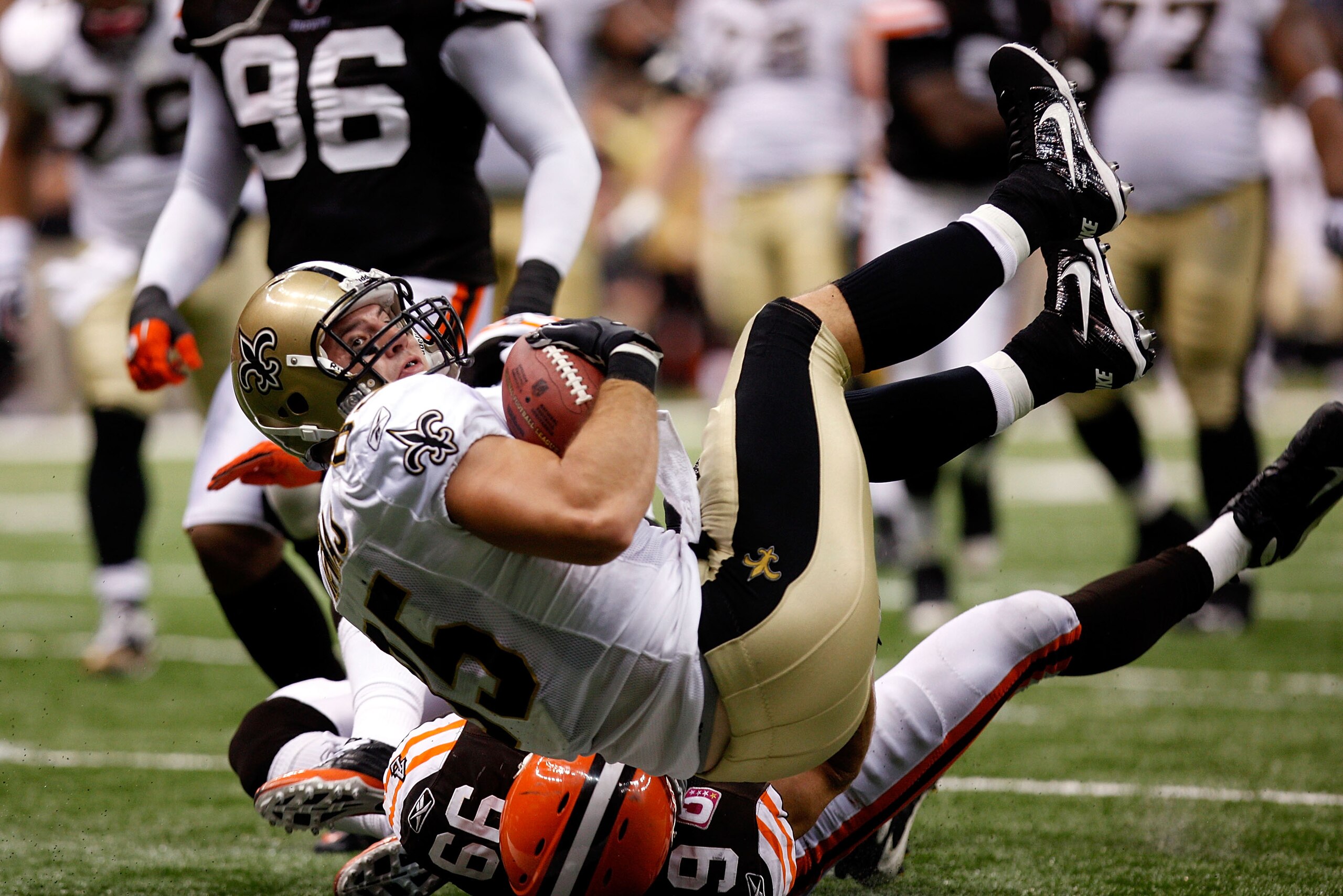 NEW ORLEANS - OCTOBER 24:   David Thomas #85 of the New Orleans Saints falls into the endzone for a touchdown over Scott Fujita #99 of the Cleveland Browns at the Louisiana Superdome on October 24, 2010 in New Orleans, Louisiana.  The Browns defeated the
