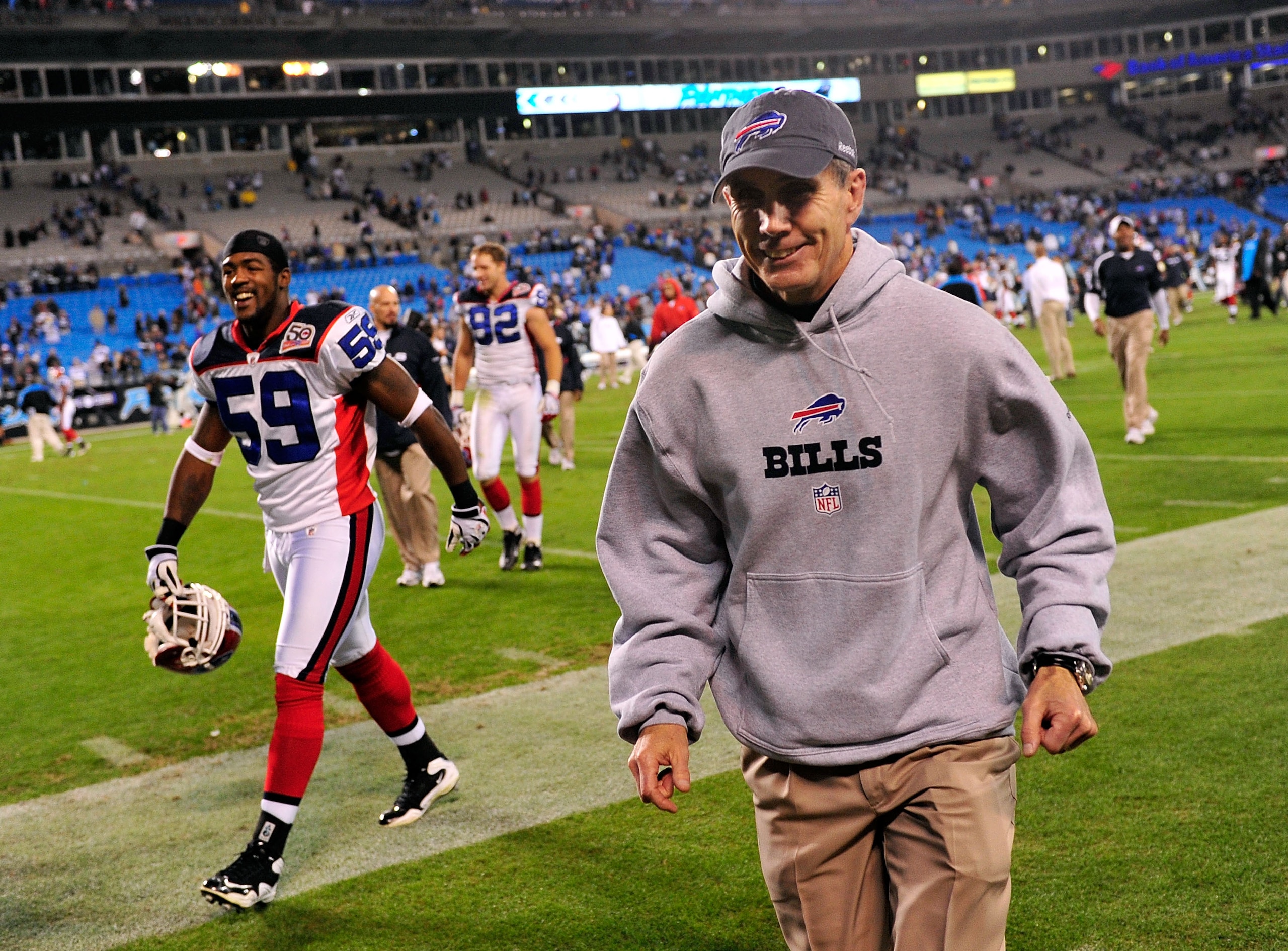 CHARLOTTE, NC - OCTOBER 25:  Coach Dick Jauron and Ashlee Palmer of the Buffalo Bills leave the field after a game against the Carolina Panthers at Bank of America Stadium on October 25, 2009 in Charlotte, North Carolina. Buffalo won 20-9. (Photo by Grant