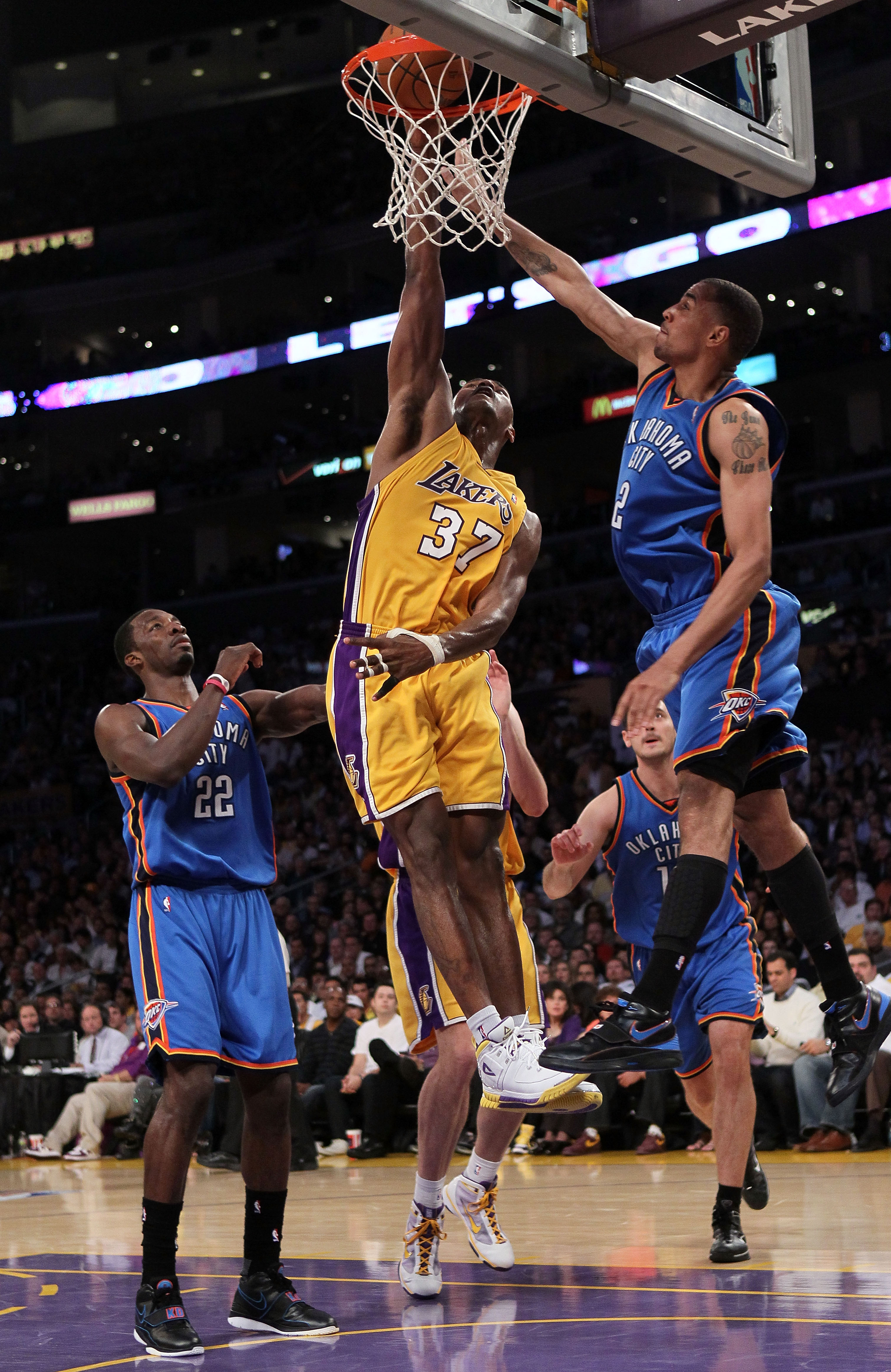 LOS ANGELES, CA - APRIL 27:  Ron Artest #37 of the Los Angeles Lakers goes up for a dunk between Jeff Green #22 and Thabo Sefolosha #2 of the Oklahoma City Thunder in the second quarter during Game Two of the Western Conference Quarterfinals of the 2010 N