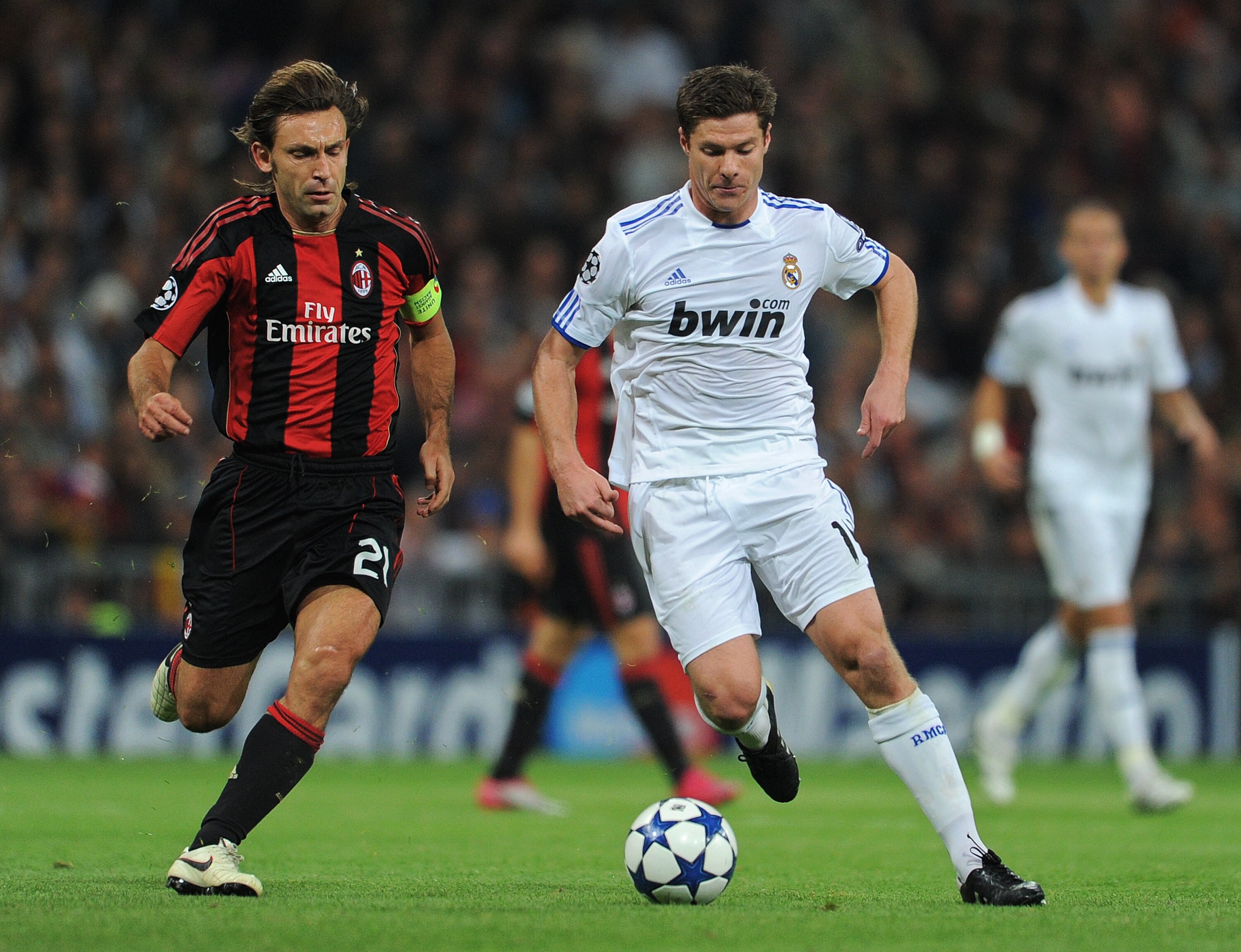 MADRID, SPAIN - OCTOBER 19:  Xabi Alonso (R) of Real Madrid duels for the ball with Andrea Pirlo of AC Milan during the UEFA Champions League group G match between Real Madrid and AC Milan at the Estadio Santiago Bernabeu on October 19, 2010 in Madrid, Sp