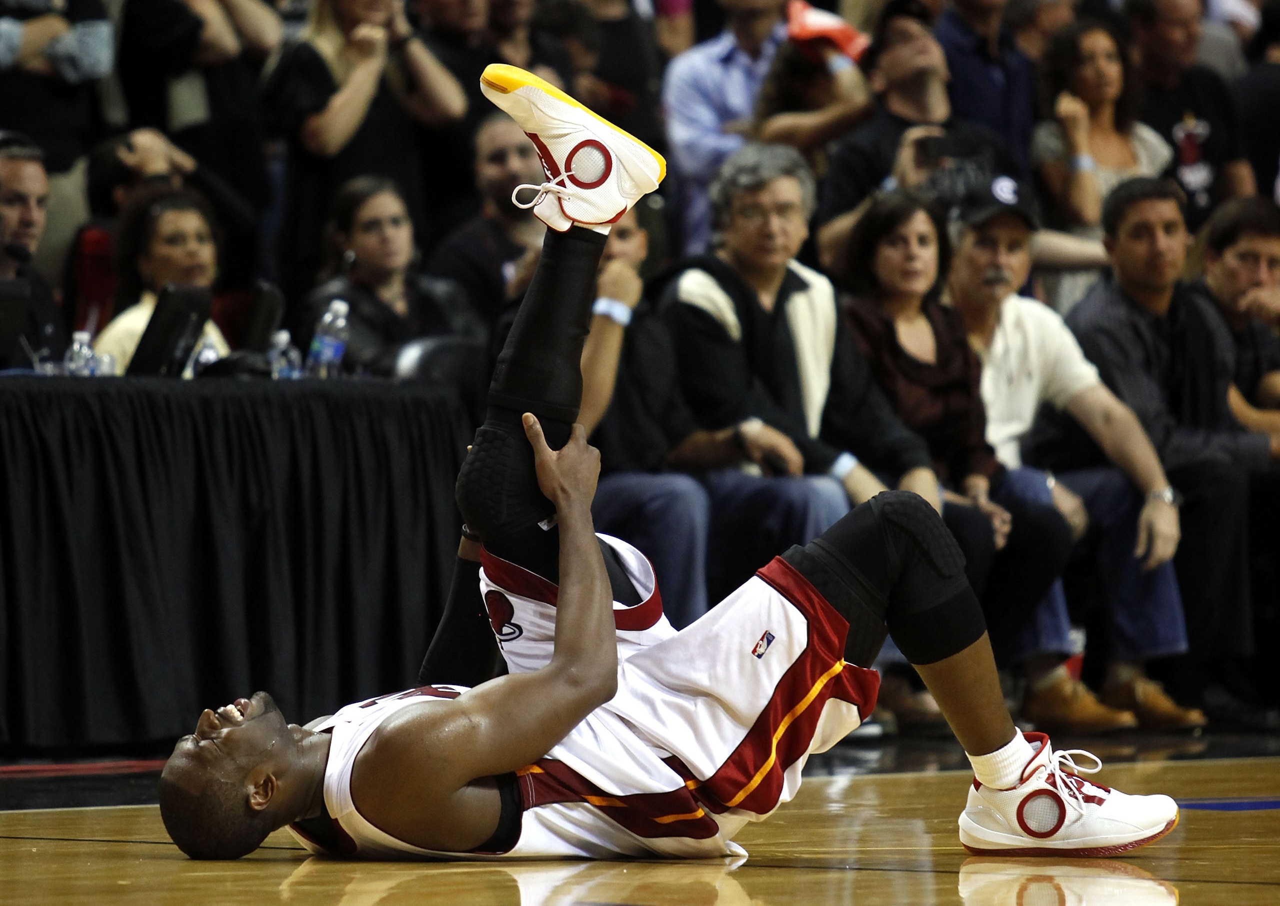 MIAMI - APRIL 23:  Guard Dwyane Wade #3 of the Miami Heat stays on the fl;oor injured during a 100-98 loss to the Boston Celtics in Game Three of the Eastern Conference Quarterfinals during the 2010 NBA Playoffs at American Airlines Arena on April 23, 201