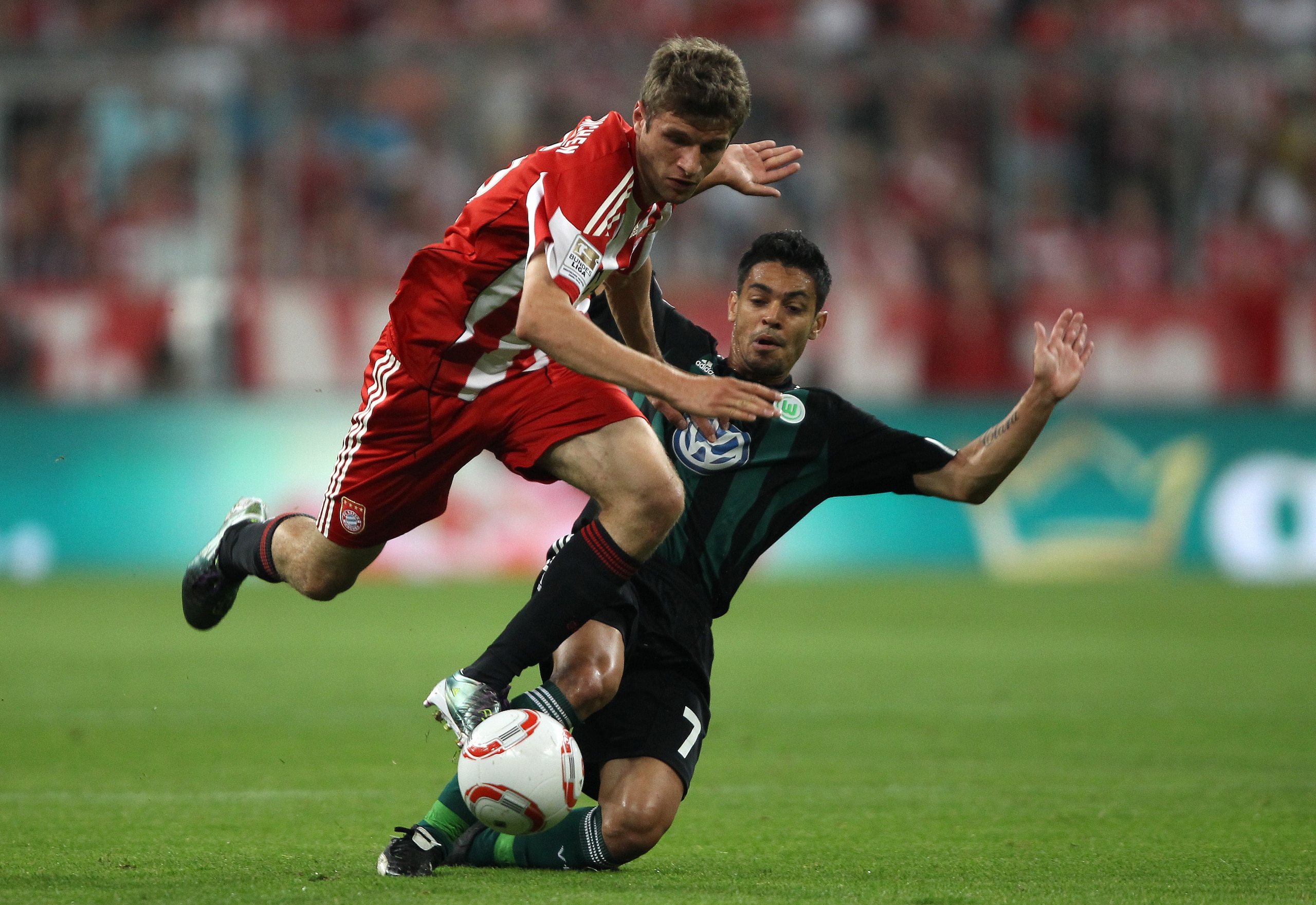 MUNICH, GERMANY - AUGUST 20: Thomas Mueller of Bayern is tackled by Josue of Wolfsburg during the Bundesliga match between FC Bayern Muenchen and VfL Wolfsburg at Allianz Arena on August 20, 2010 in Munich, Germany. (Photo by Clive Brunskill/Getty Image MUNICH, GERMANY - AUGUST 20: Thomas Mueller of Bayern is tackled by Josue of Wolfsburg during the Bundesliga match between FC Bayern Muenchen and VfL Wolfsburg at Allianz Arena on August 20, 2010 in Munich, Germany. (Photo by Clive Brunskill/Getty Image