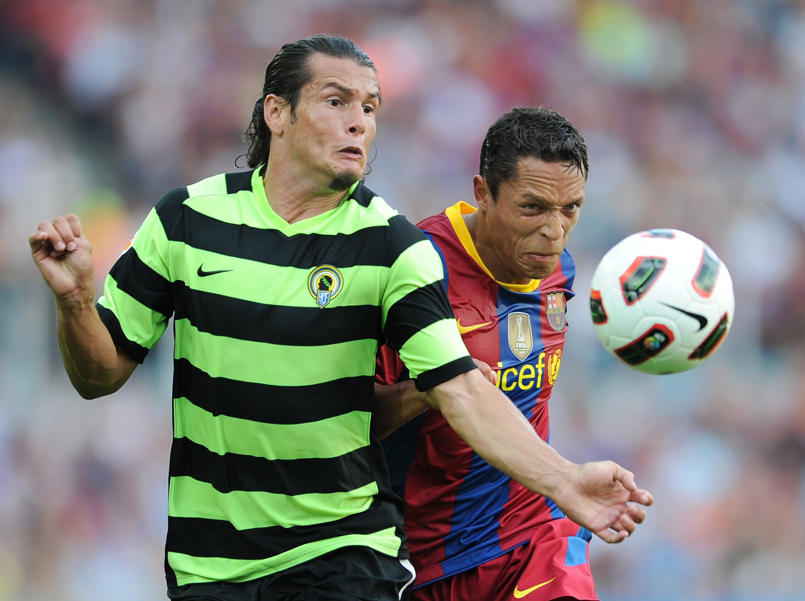 BARCELONA, SPAIN - SEPTEMBER 11:  Adriano (R) of Barcelona fights for the ball with Nelson Valdez of Hercules during the La Liga match between Barcelona and Hercules at the Camp Nou stadium on September 11, 2010 in Barcelona, Spain.  (Photo by Jasper Juin