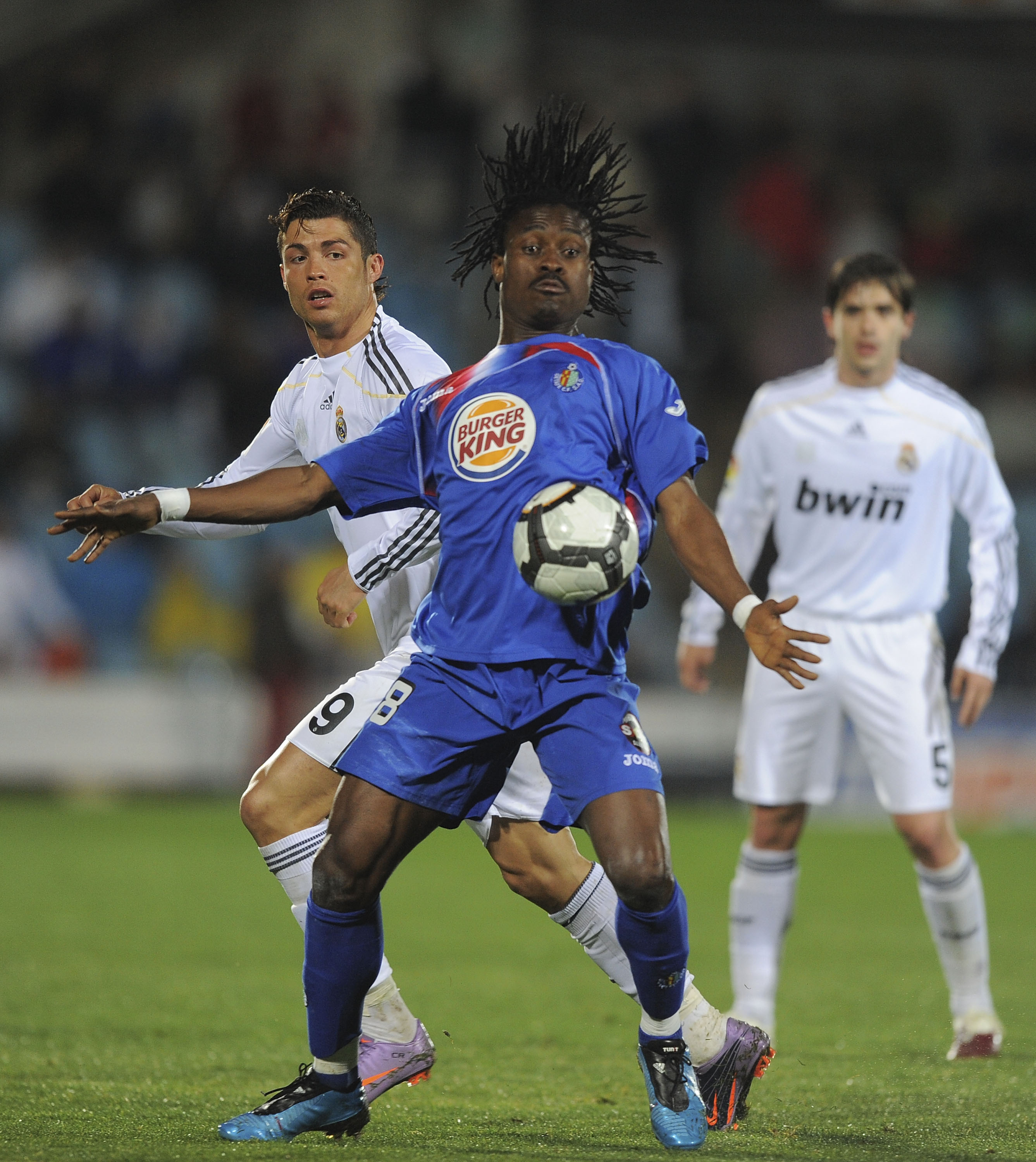 GETAFE, SPAIN - MARCH 25:  Derek Boateng (R) of Getafe robs the ball from Cristiano Ronaldo of Real Madrid during La Liga match between Getafe and Real Madrid at the Coliseum Alfonso Perez stadium on March 25, 2010 in Getafe, Spain.  (Photo by Denis Doyle