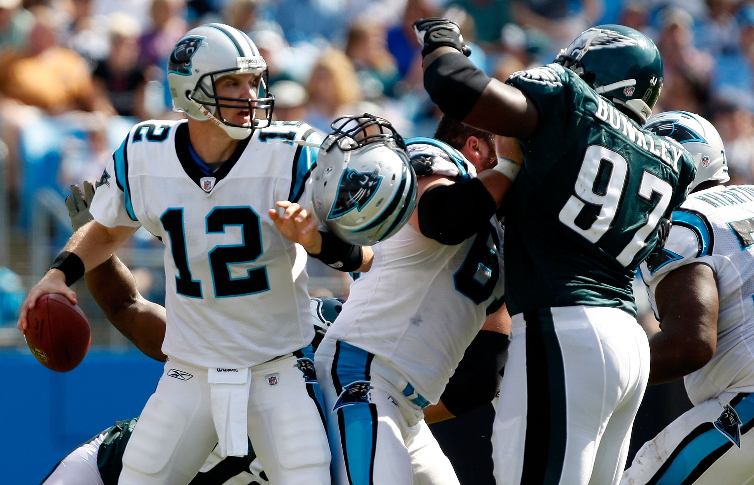 CHARLOTTE, NC - SEPTEMBER 13:  Quarterback Josh McCown #12 of the Carolina Panthers gets pressured by Brodrick Bunkley #97 of the Philadelphia Eagles during the NFL season opener at Bank of America Stadium on September 13, 2009 in Charlotte, North Carolin