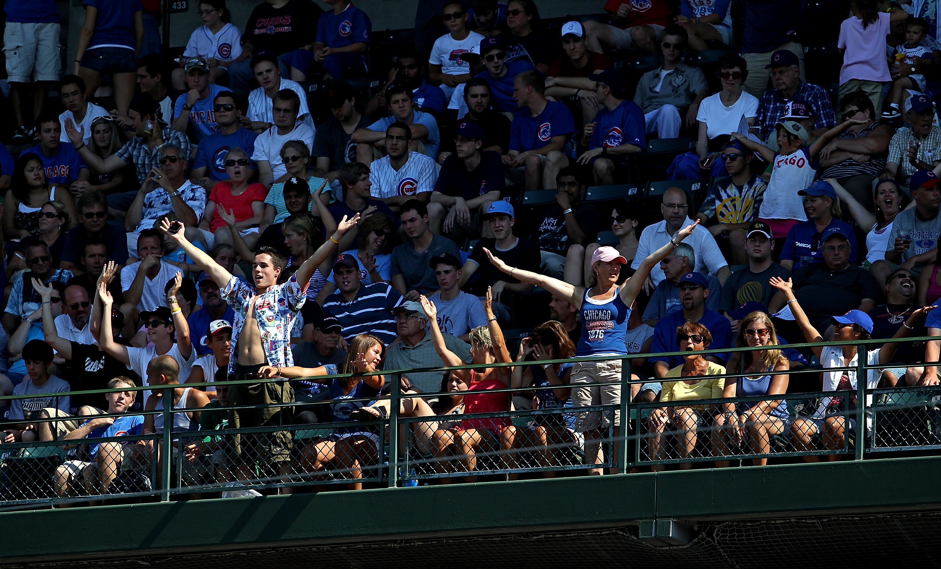 CHICAGO - JULY 21: Fans in the upper deck do a dance to the song 'YMCA' during a pitching change as the Chicago Cubs take on the Houston Astros at Wrigley Field on July 21, 2010 in Chicago, Illinois. The Astros defeated the Cubs 4-3 in 12 innings. (Photo 
