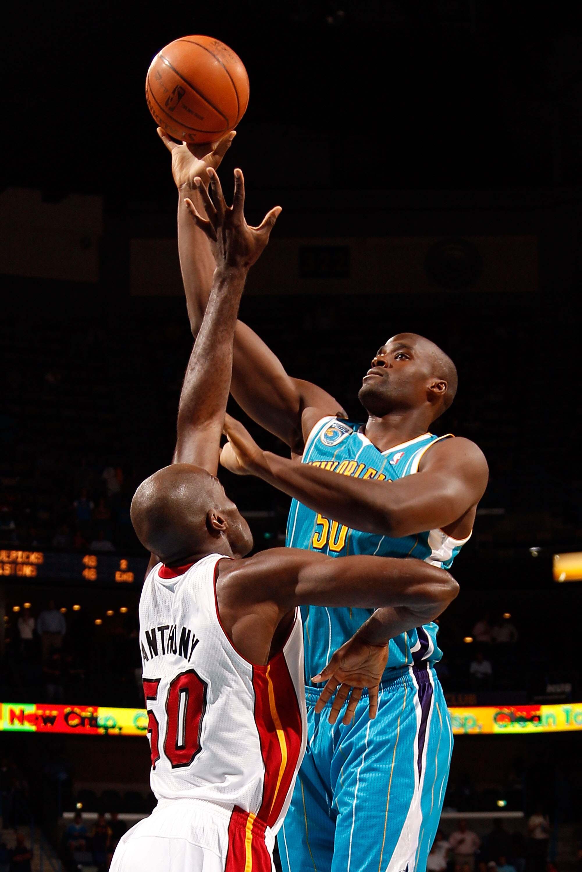 NEW ORLEANS - OCTOBER 13:  Emeka Okafor #50 of the New Orleans Hornets makes a shot over Joel Anthony #50 of the Miami Heat at the New Orleans Arena on October 13, 2010 in New Orleans, Louisiana. NOTE TO USER: User expressly acknowledges and agrees that,