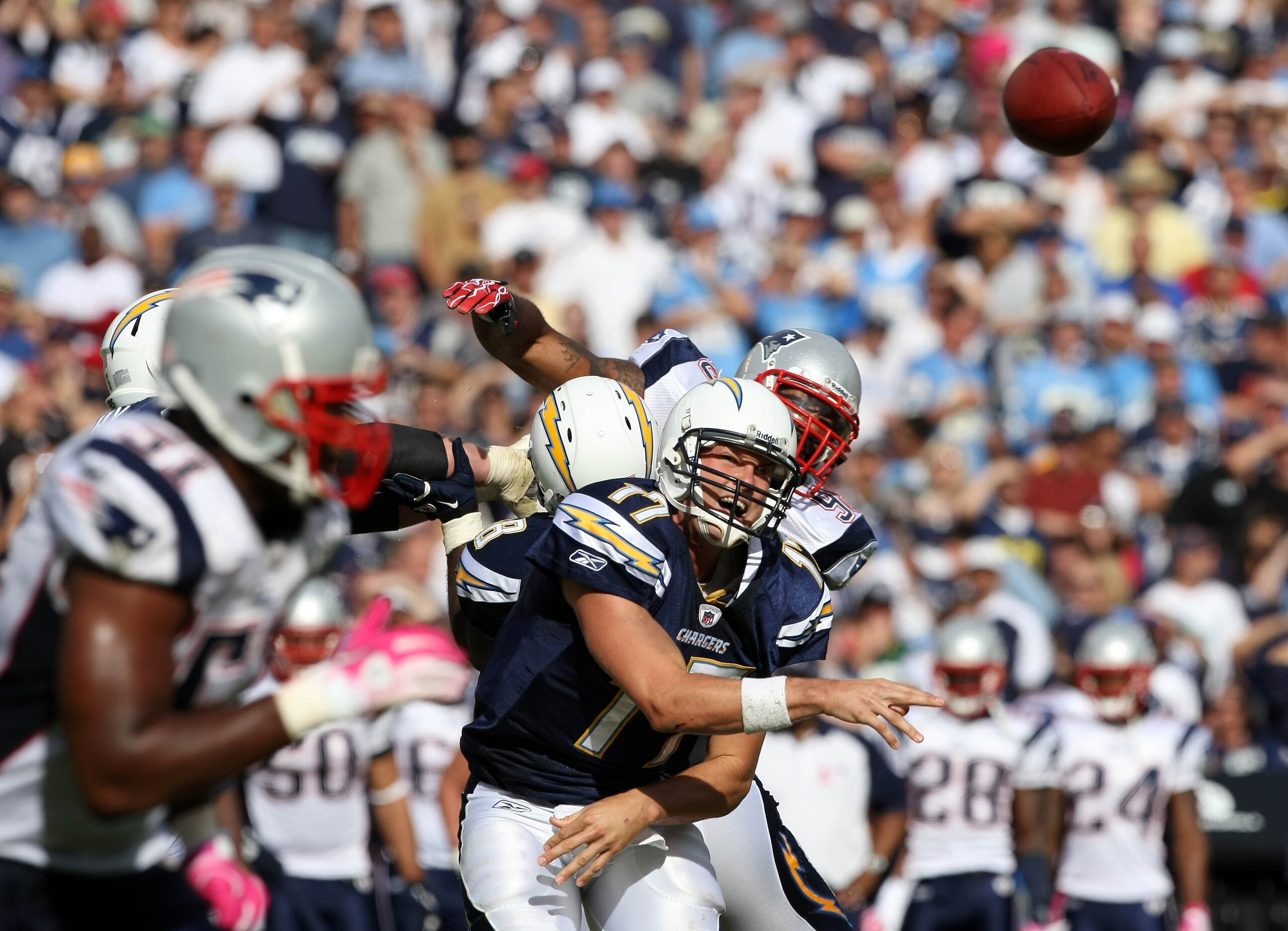 SAN DIEGO - OCTOBER 24:  Quarterback Philip Rivers #17 of the San Diego Chargers throws the ball against the pressure of the New England Patriots defense during NFL game on October 24, 2010 at Qualcomm Stadium in San Diego, California. (Photo by Donald Mi