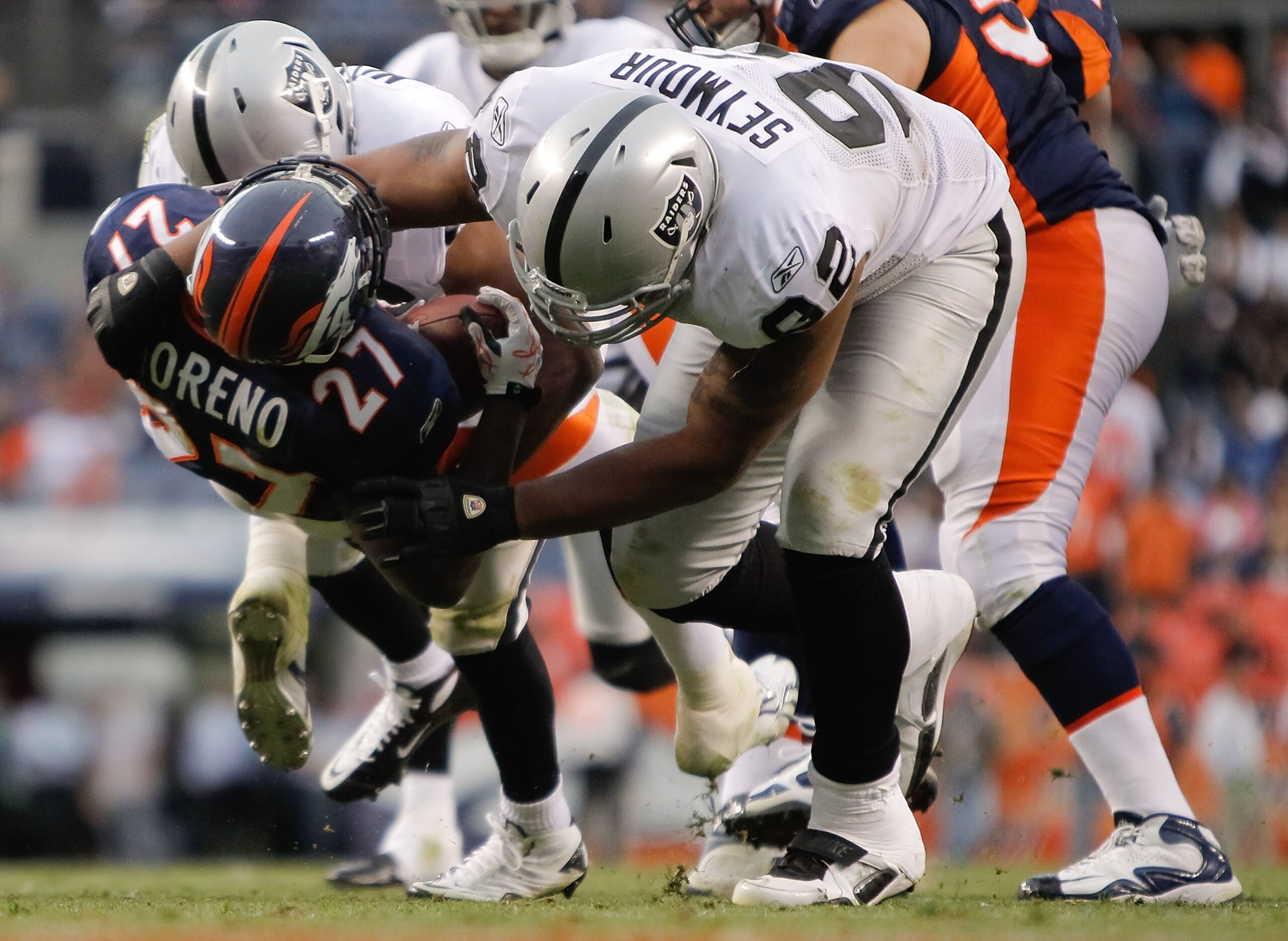 DENVER - OCTOBER 24: Defensive end Richard Seymour #92 of the Oakland Raiders throws running back Knowshon Moreno #27 of the Denver Broncos to the ground in the fourth quarter at INVESCO Field at Mile High on October 24, 2010 in Denver, Colorado. The Rai DENVER - OCTOBER 24: Defensive end Richard Seymour #92 of the Oakland Raiders throws running back Knowshon Moreno #27 of the Denver Broncos to the ground in the fourth quarter at INVESCO Field at Mile High on October 24, 2010 in Denver, Colorado. The Rai