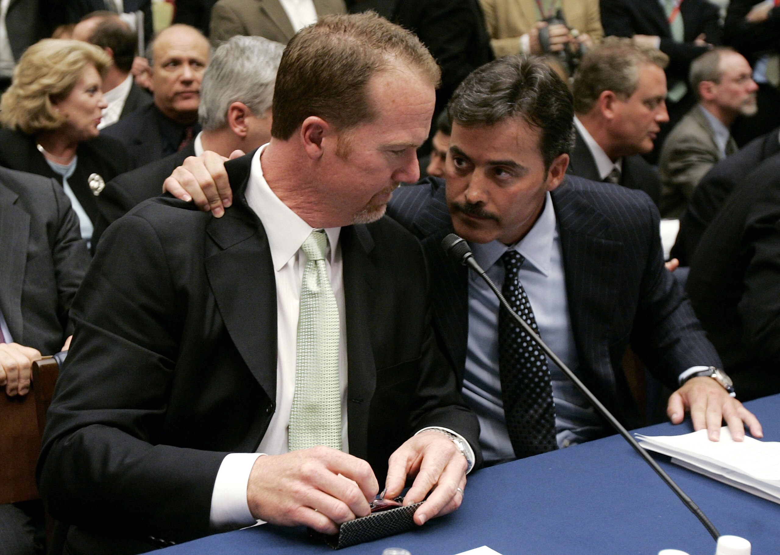 WASHINGTON - MARCH 17:  Former St. Louis Cardinal Mark McGwire (L) talks with Rafael Palmeiro of the Baltimore Orioles during a House Committe session investigating Major League Baseball's effort to eradicate steroid use on Capital Hill March 17, 2005 in 