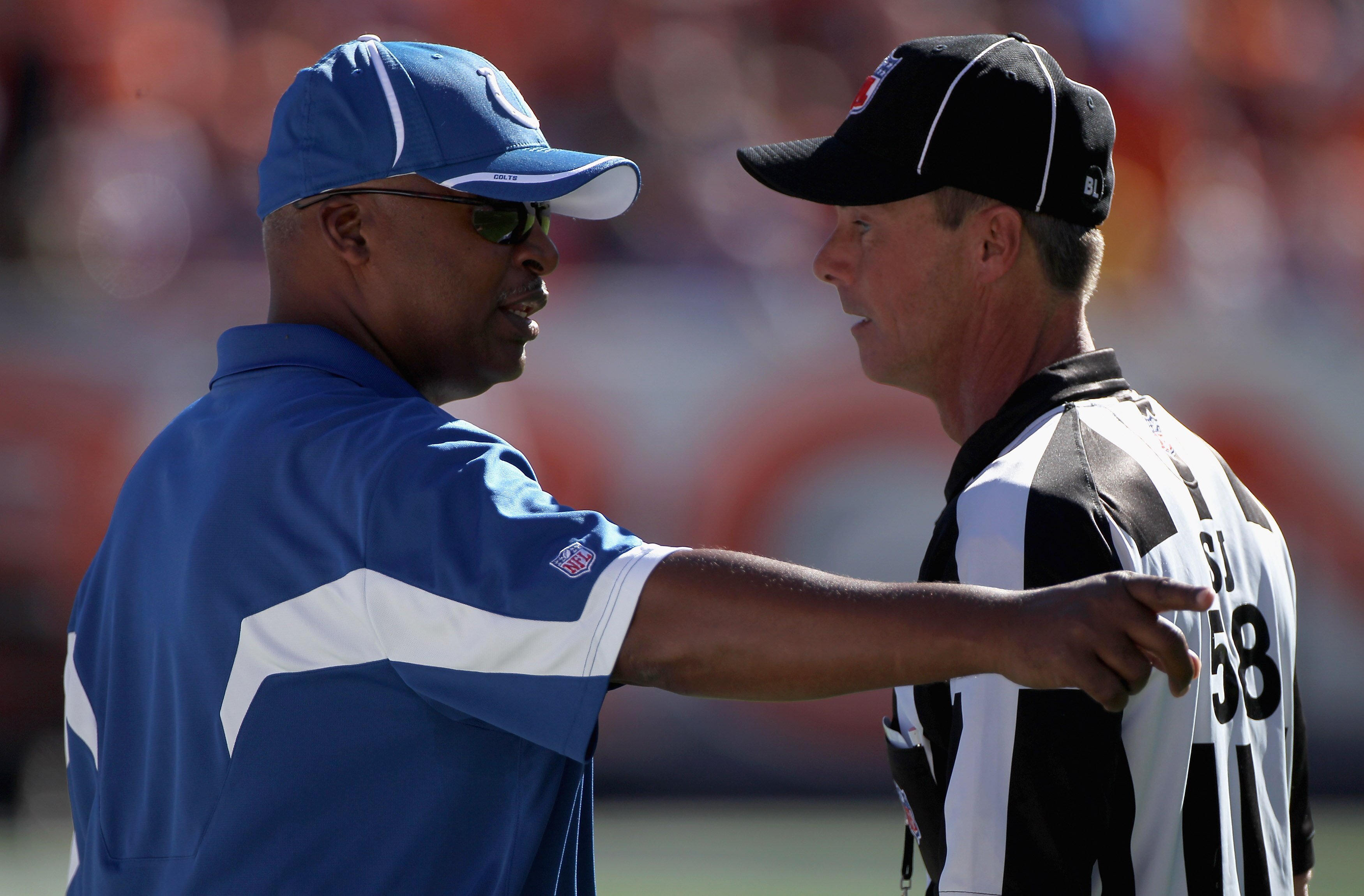 DENVER - SEPTEMBER 26:  Head coach Jim Caldwell of the Indianapolis Colts questions a call with side judge Jimmy DeBell as the Colts face the Denver Broncos at INVESCO Field at Mile High on September 26, 2010 in Denver, Colorado.  (Photo by Doug Pensinger
