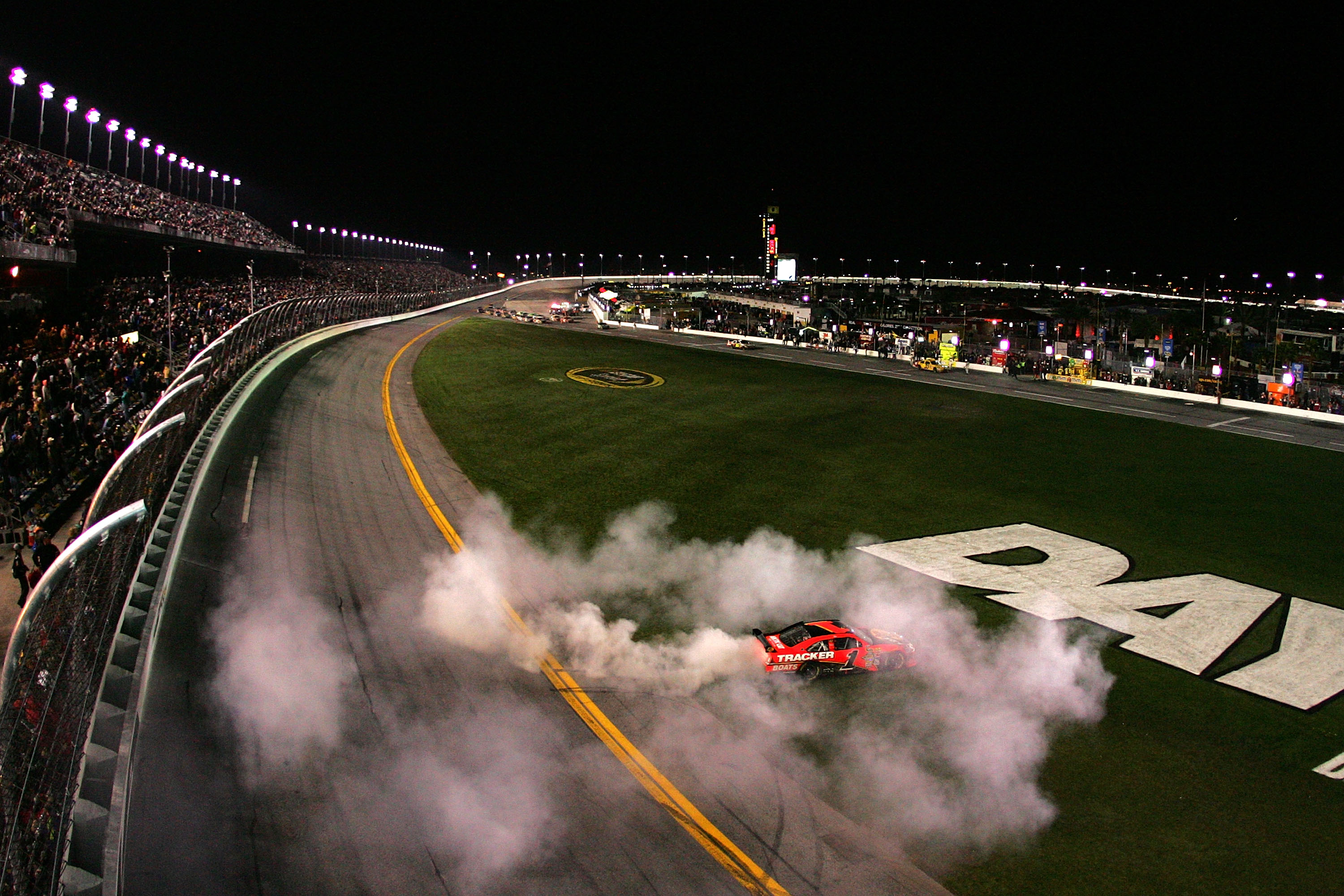 DAYTONA BEACH, FL - FEBRUARY 14:  Jamie McMurray, driver of the #1 Bass Pro Shops/Tracker Boats Chevrolet, celebrates with a burnout after winning the NASCAR Sprint Cup Series Daytona 500 at Daytona International Speedway on February 14, 2010 in Daytona B