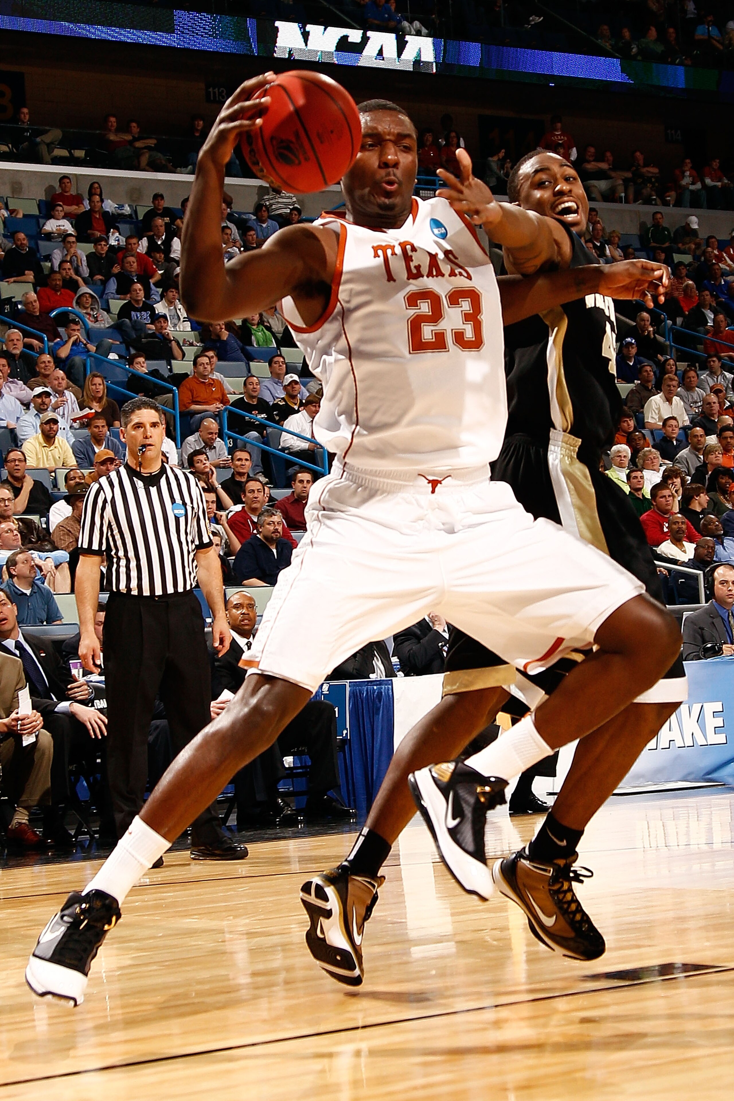 NEW ORLEANS - MARCH 18:  Jordan Hamilton #23 of the Texas Longhorns fights for a loose ball with L.D. Williams #42 of the Wake Forest Demon Deacons during the first round of the 2010 NCAA menï¿½s basketball tournament at the New Orleans Arena on March 18, 2