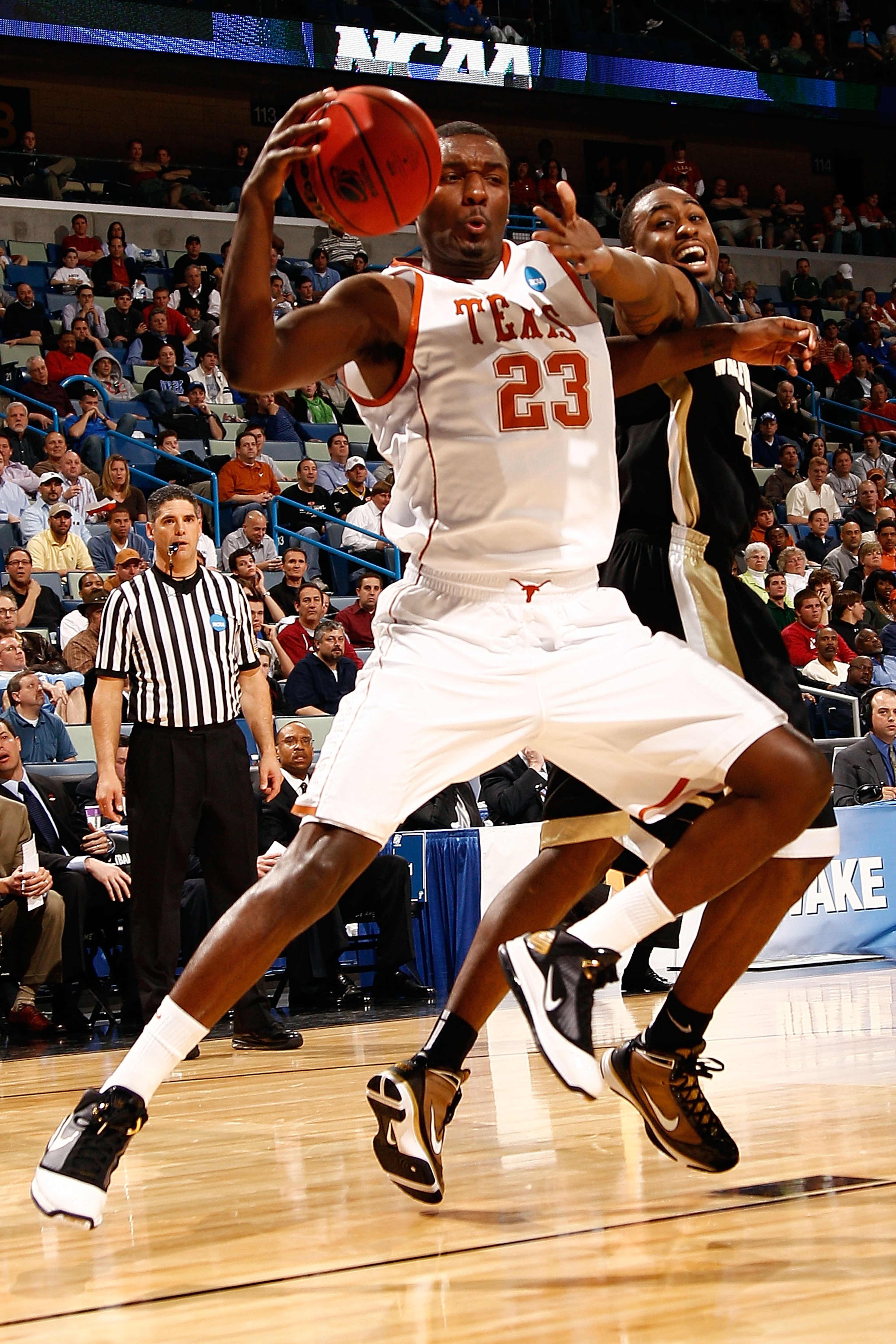 NEW ORLEANS - MARCH 18:  Jordan Hamilton #23 of the Texas Longhorns fights for a loose ball with L.D. Williams #42 of the Wake Forest Demon Deacons during the first round of the 2010 NCAA menï¿½s basketball tournament at the New Orleans Arena on March 18, 2