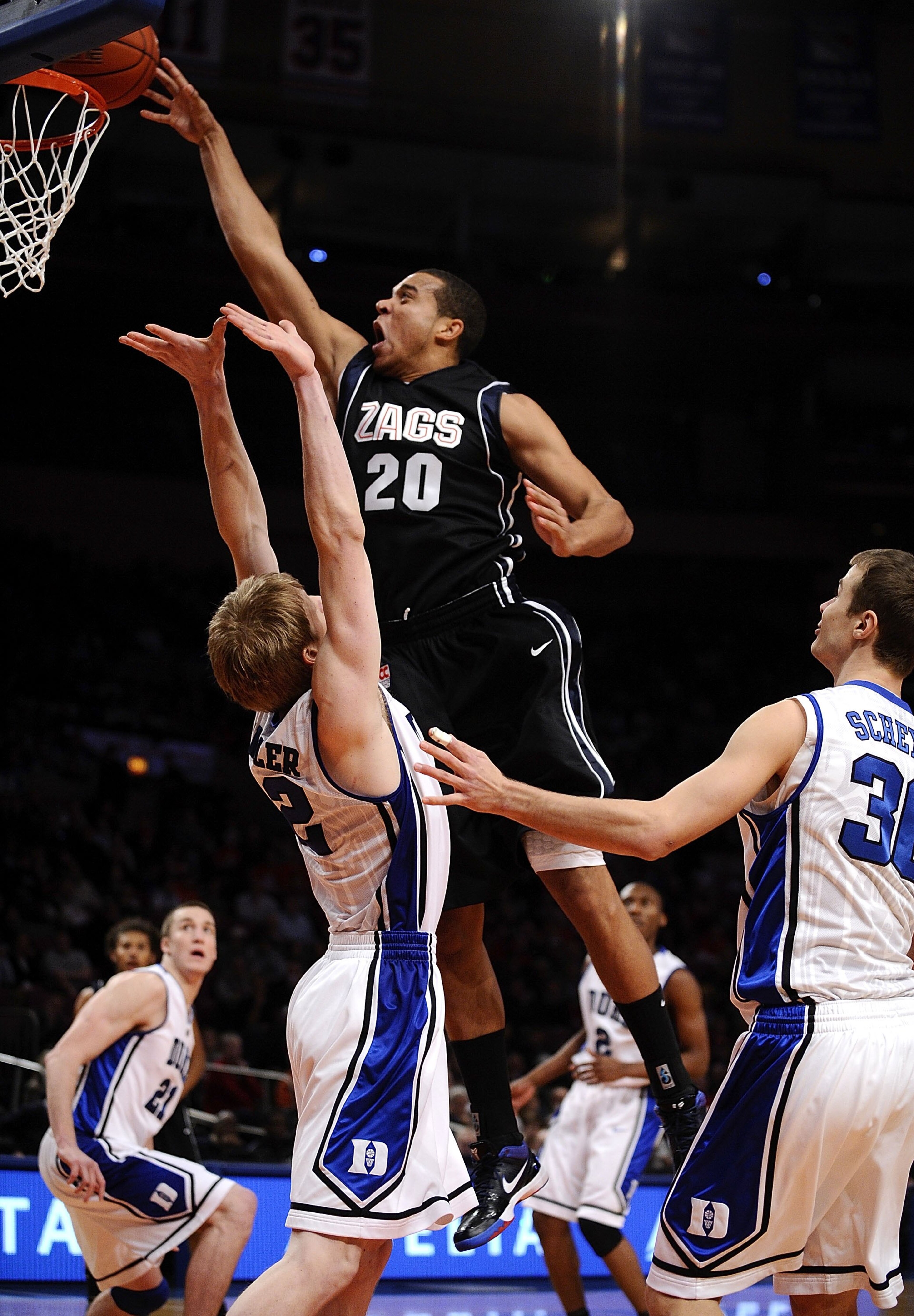 NEW YORK - DECEMBER 19:  Elias Harris #20 of the Gonzaga Bulldogs puts up a shot over Kyle Singler #12 of the Duke Blue Devils in the Aeropostale Classic at Madison Square Garden on December 19, 2009 in New York City.  (Photo by Jeff Zelevansky/Getty Imag