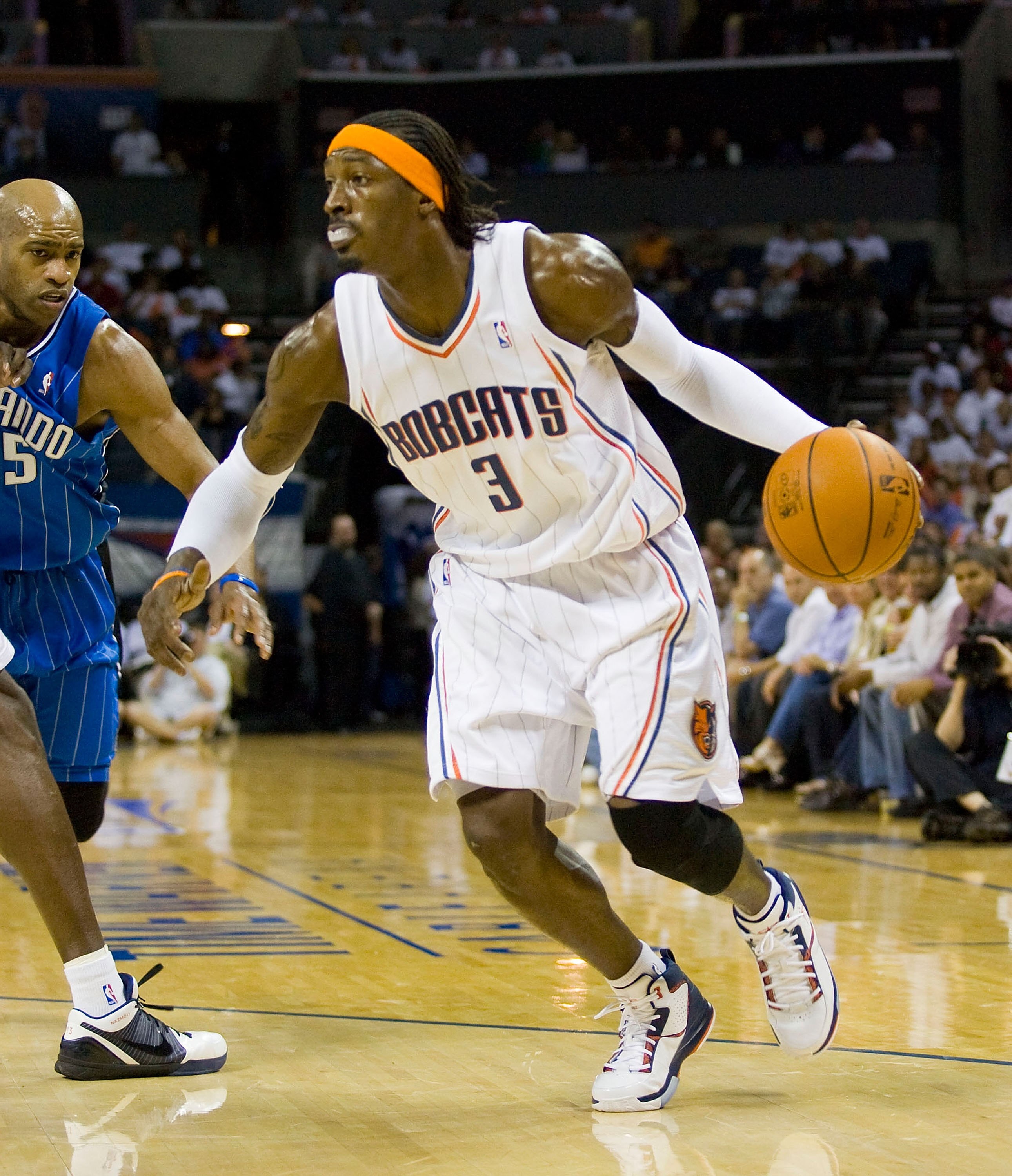 CHARLOTTE, NC - APRIL 26: Gerald Wallace #3 of the Charlotte Bobcats dribbles away from Vince Carter #15 of the Orlando Magic at Time Warner Cable Arena on April 26, 2010 in Charlotte, North Carolina.  The Magic defeated the Bobcats 99-90 to complete the