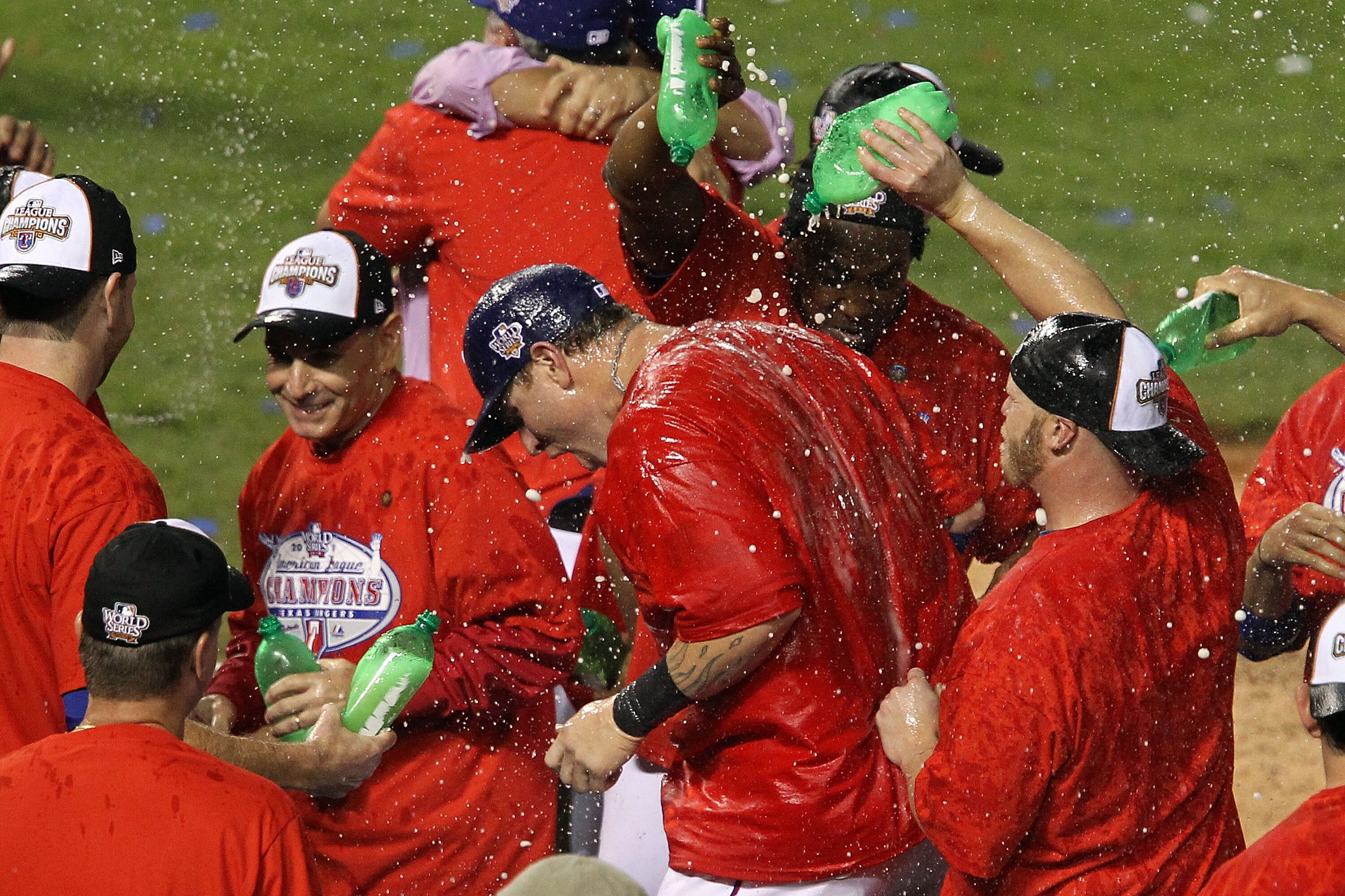 ARLINGTON, TX - OCTOBER 22:  Josh Hamilton #32 (C) of the Texas Rangers is sprayed with soda by teammates as they celebrate on the field after defeating the New York Yankees 6-1 in Game Six of the ALCS to advance to the World Series during the 2010 MLB Pl