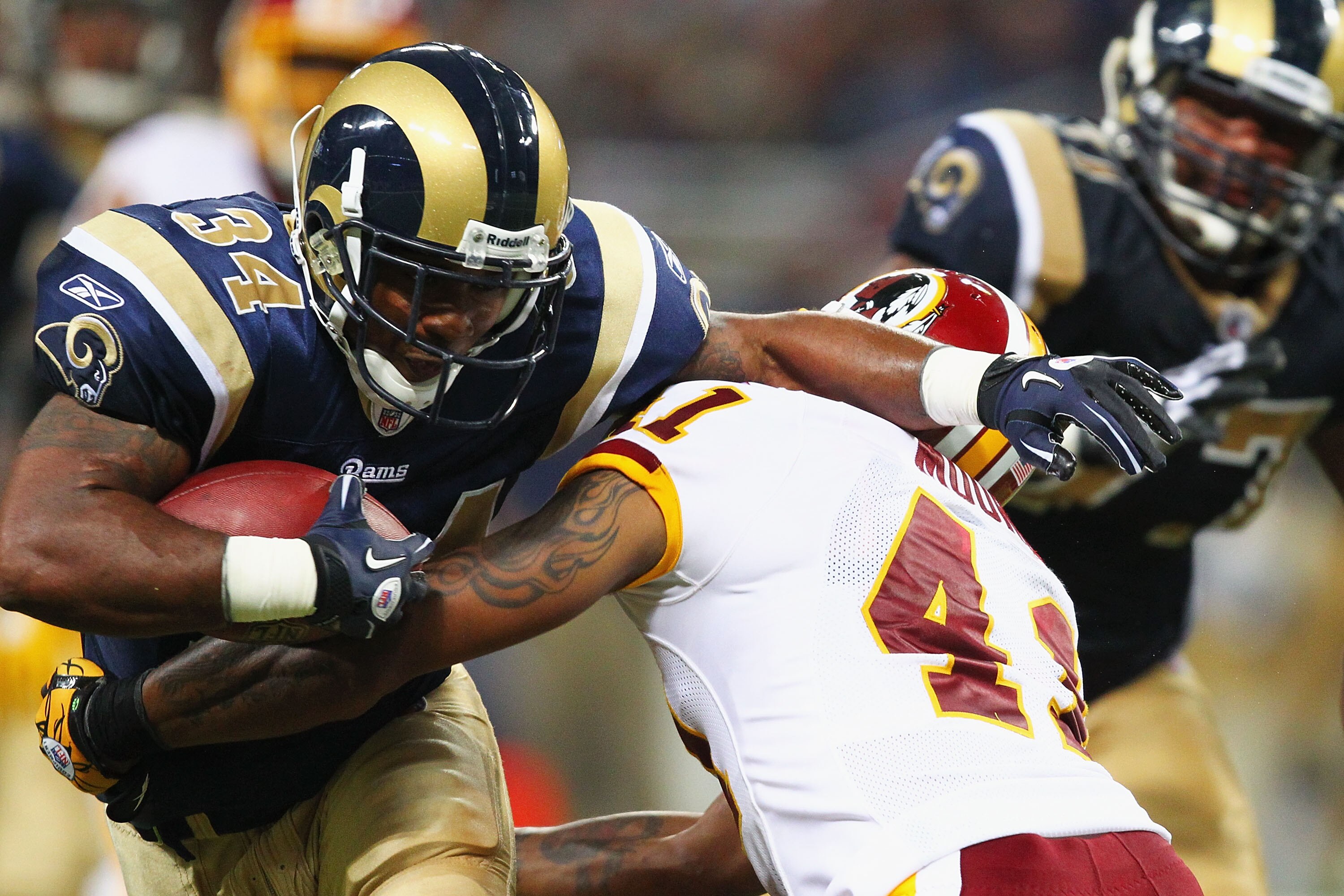ST. LOUIS - SEPTEMBER 26: Kenneth Darby #34 of the St. Louis Rams rushes against the Washington Redskins at the Edward Jones Dome on September 26, 2010 in St. Louis, Missouri.  The Rams beat the Redskins 30-16.  (Photo by Dilip Vishwanat/Getty Images)