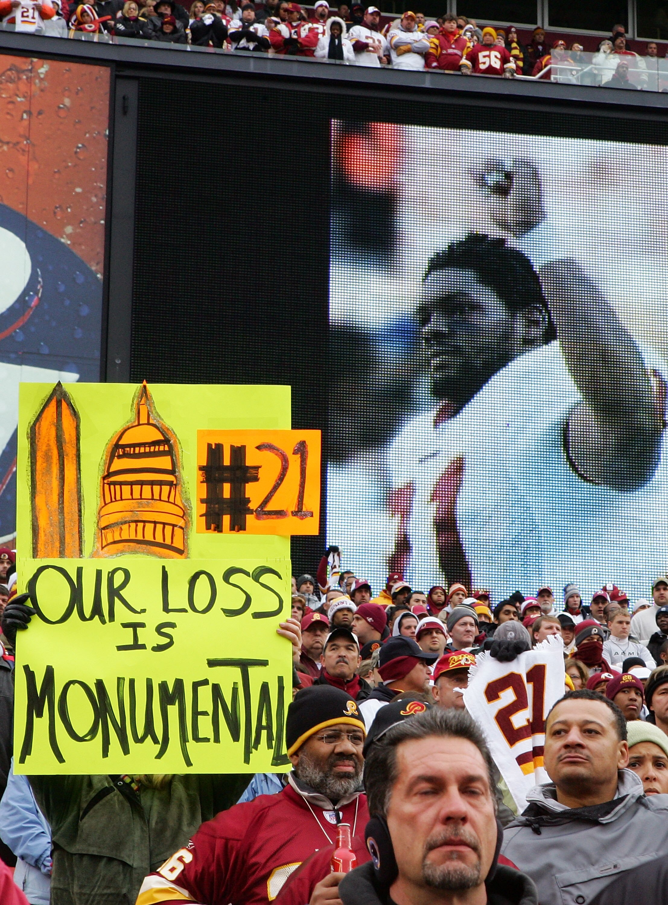 LANDOVER, MD - DECEMBER 02:  A fan of the Washington Redskins hold up a sign honoring the late Sean Taylor prior to the game against the Buffalo Bills on December 2, 2007 at FedEx Field in Landover, Maryland.  (Photo by Jim McIsaac/Getty Images)
