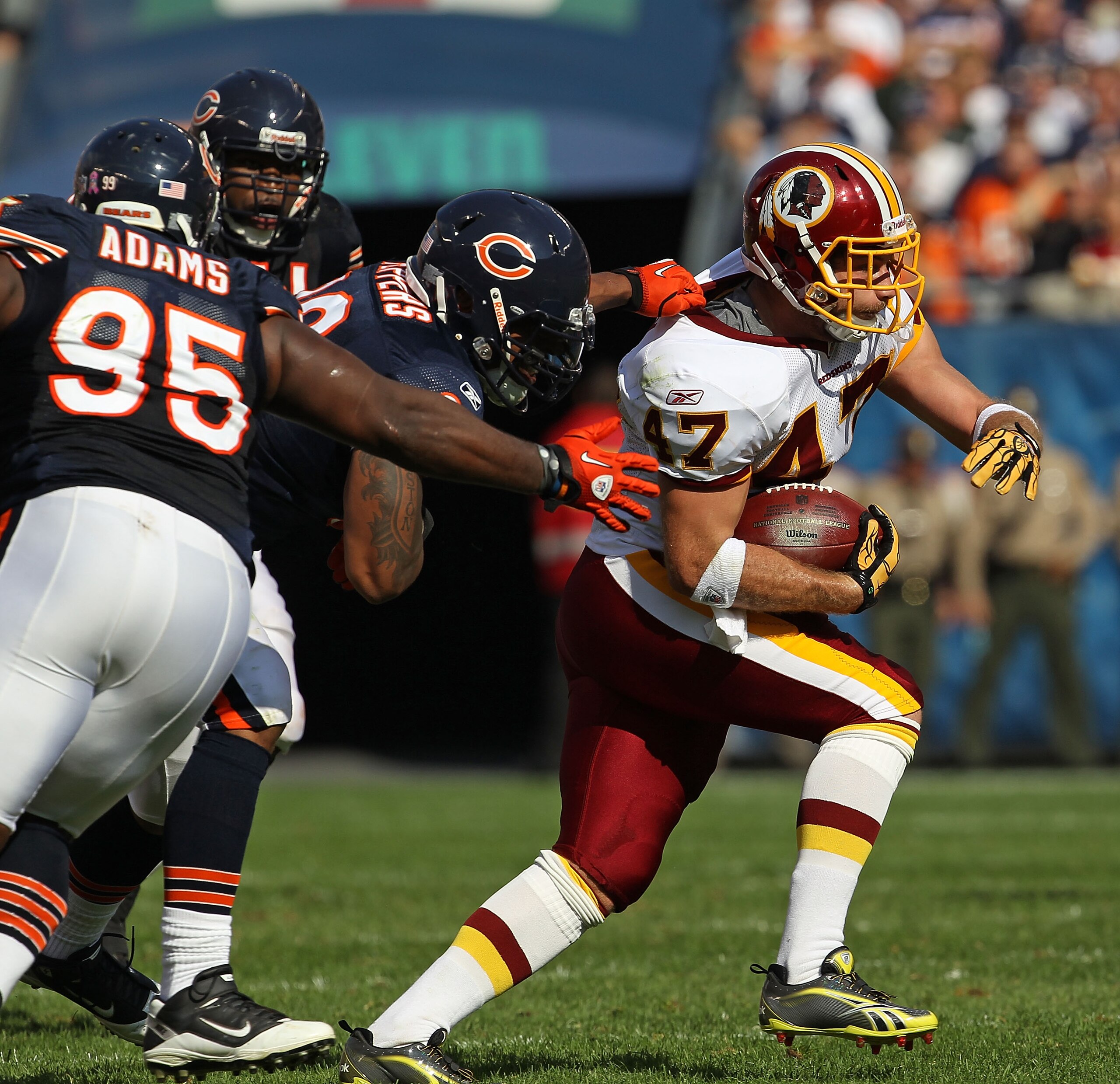 CHICAGO - OCTOBER 24: Chris Cooley #47 of the Washington Redskins runs pursued by Julius Peppers #90 and Anthony Adams #95 of the Chicago Bears at Soldier Field on October 24, 2010 in Chicago, Illinois. The Redskins defeated the Bears 17-14.  (Photo by Jo