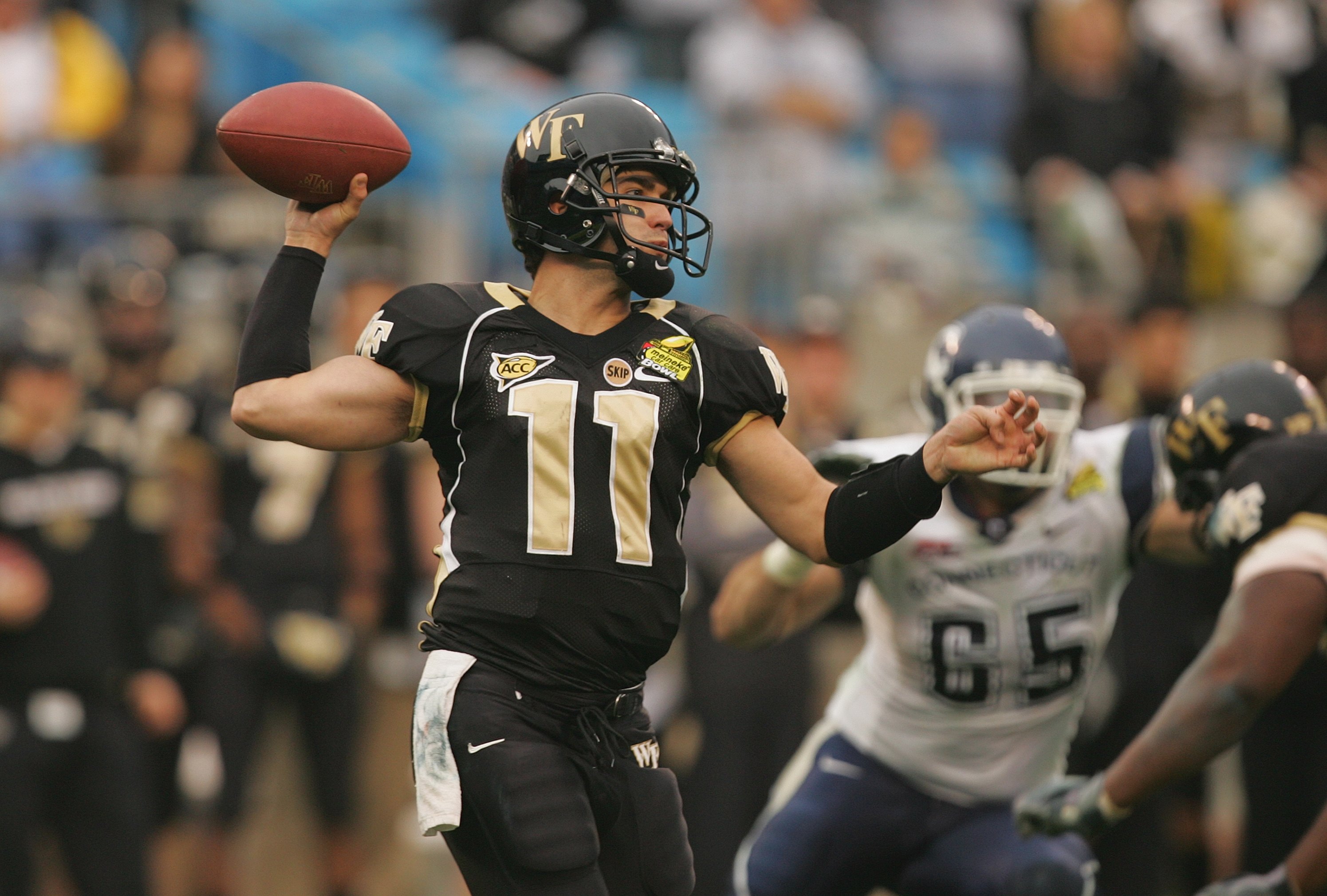 CHARLOTTE, NC - DECEMBER 29:  Riley Skinner #11 of the Wake Forest Demon Deacons throws a pass against the Connecticut Huskies during their game at Bank of America Stadium on December 29, 2007 in Charlotte, North Carolina. (Photo by Streeter Lecka/Getty I