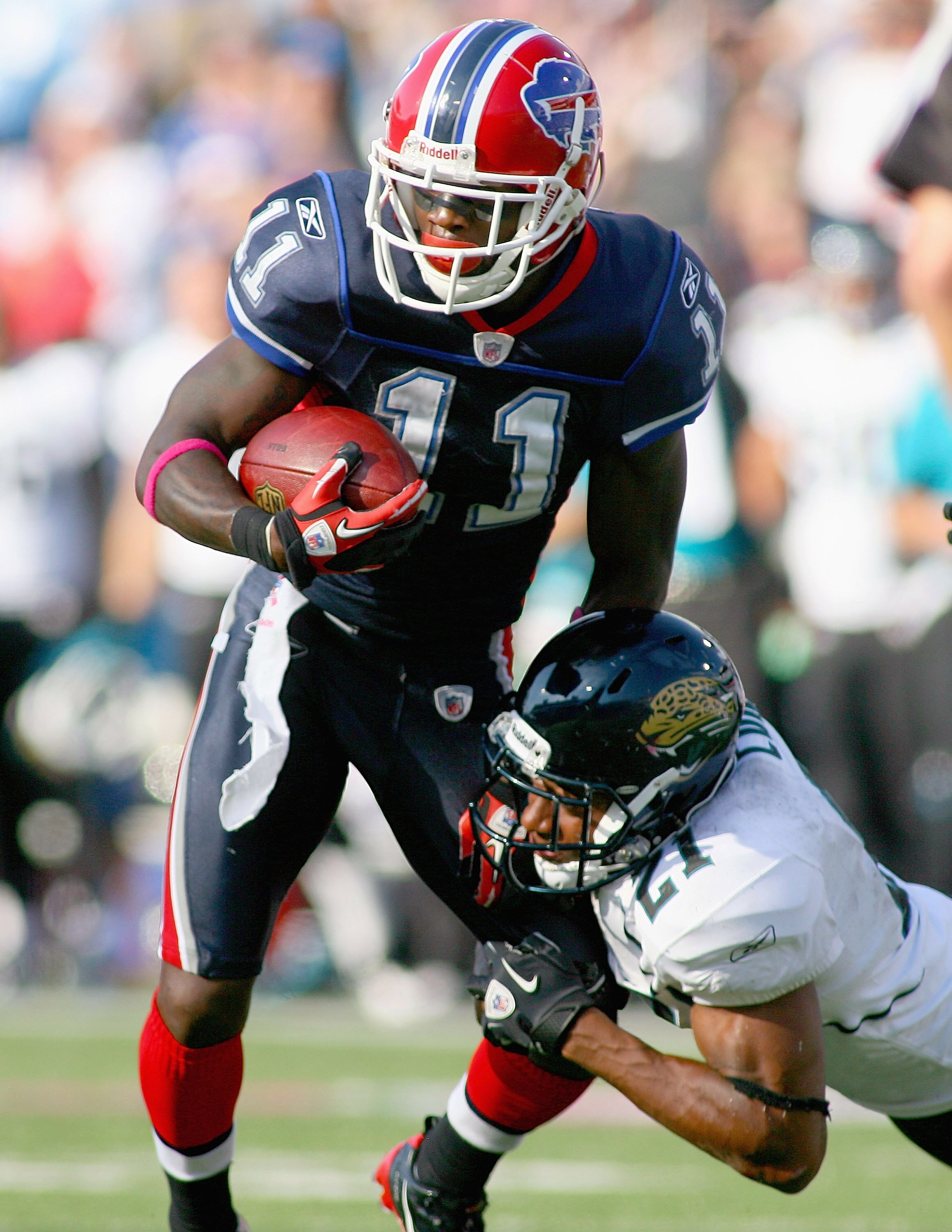 ORCHARD PARK, NY - OCTOBER 10: Roscoe Parrish #11 of the Buffalo Bills tries to get away from Derek Cox #21 of the Jacksonville Jaguars at Ralph Wilson Stadium on October 10, 2010 in Orchard Park, New York. Jackson ville won 36-26. (Photo by Rick Stewart/