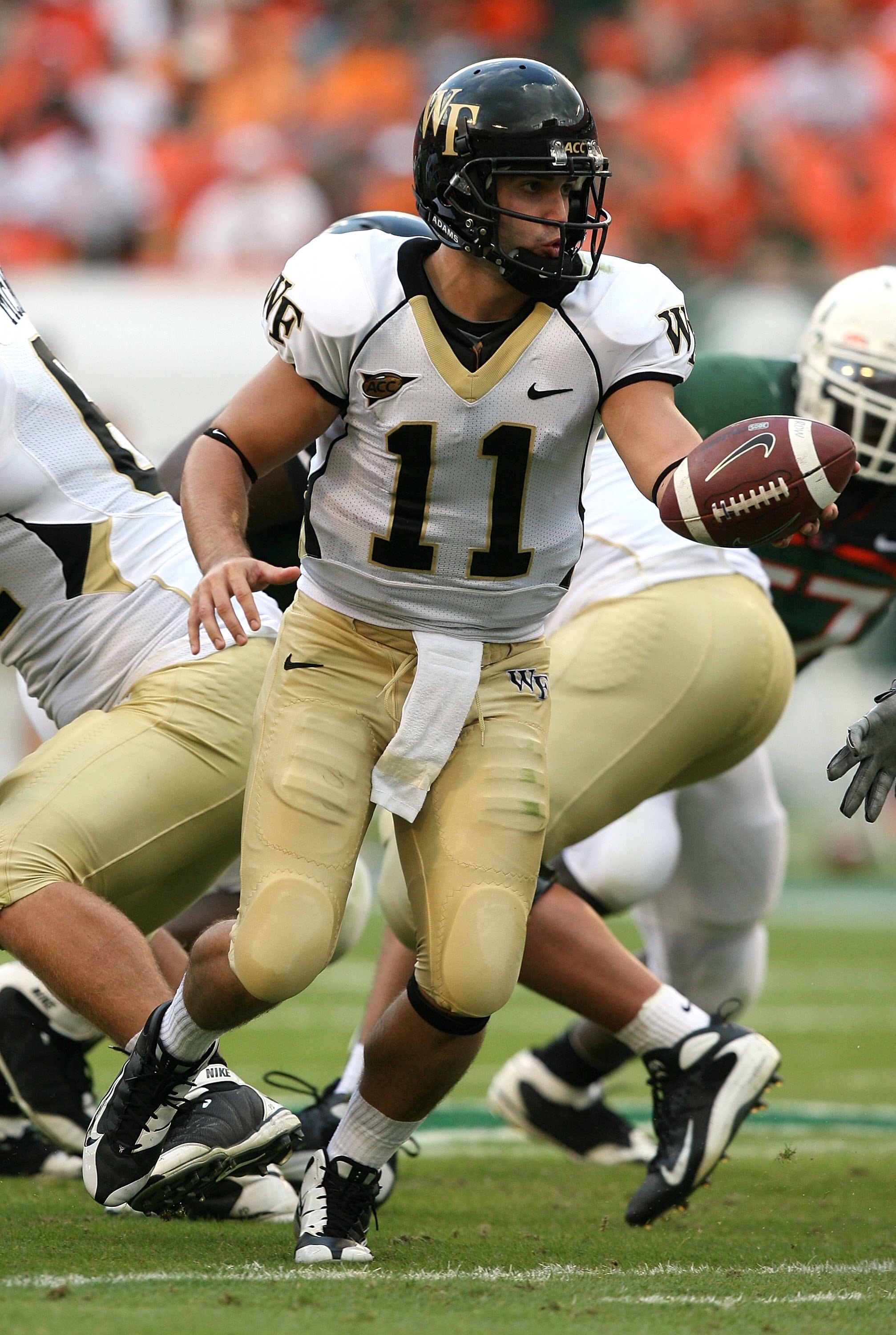 MIAMI - OCTOBER 25:  Quarterback Riley Skinner #11 of the Wake Forest Demon Decons looks to hand the ball off while taking on the Miami Hurricanes at Dolphin Stadium on October 25, 2008 in Miami, Florida. Miami defeated Wake Forest 16-10.  (Photo by Doug 