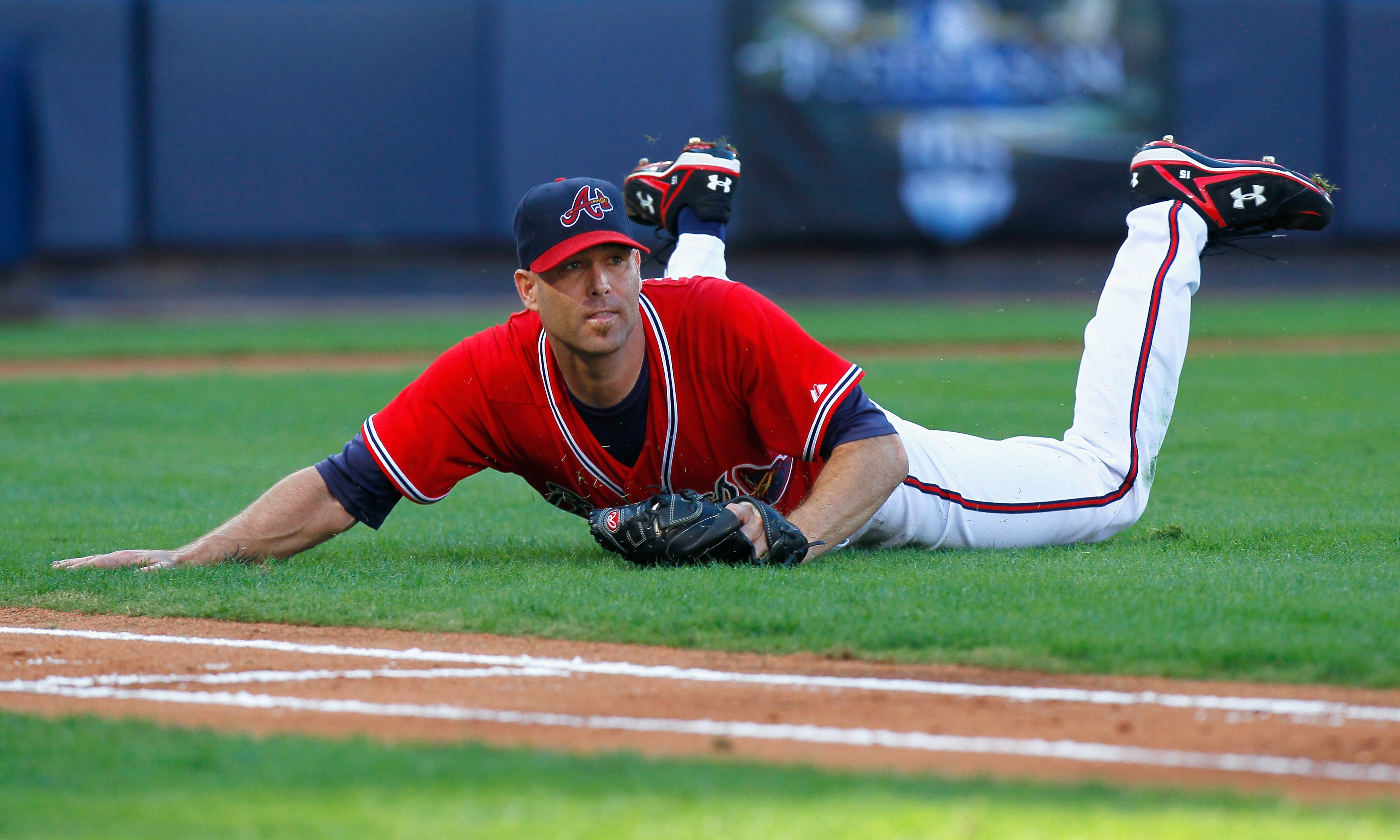ATLANTA - OCTOBER 10:  Starting pitcher Tim Hudson #15 of the Atlanta Braves pitches slides in the infield after catching a bunt by Jonathan Sanchez #57 of the San Francisco Giants during Game Three of the NLDS of the 2010 MLB Playoffs at Turner Field on