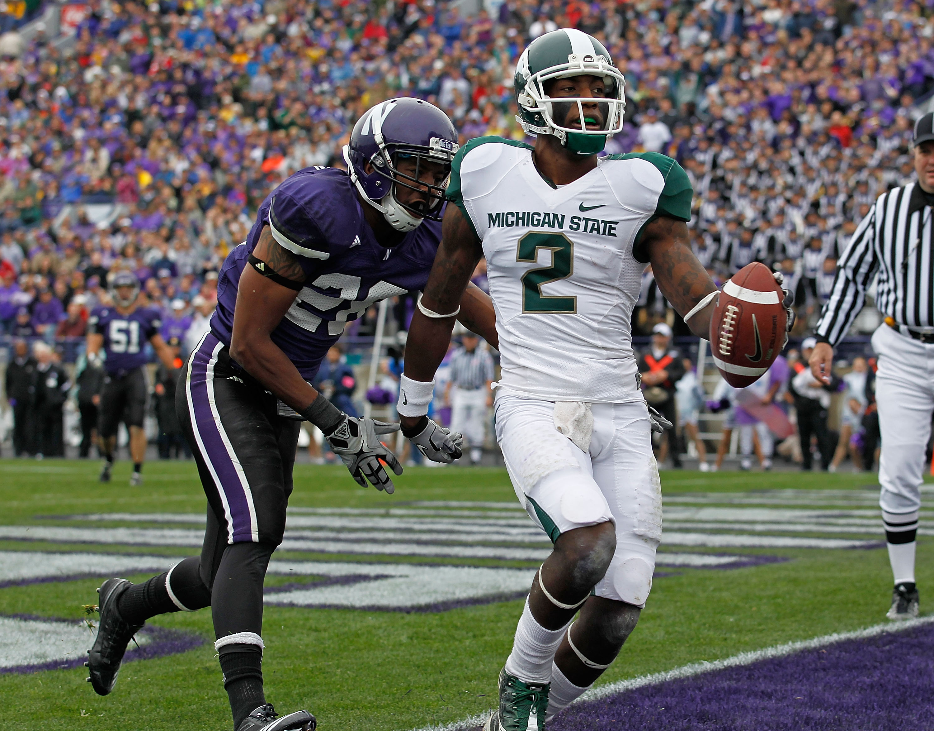 EVANSTON, IL - OCTOBER 23: Mark Dell #2 of the Michigan State Spartans scores a touchdown in front of Justan Vaughn #28 of the Northwestern Wildcats at Ryan Field on October 23, 2010 in Evanston, Illinois. Michigan State defeated Northwestern 35-27. (Phot EVANSTON, IL - OCTOBER 23: Mark Dell #2 of the Michigan State Spartans scores a touchdown in front of Justan Vaughn #28 of the Northwestern Wildcats at Ryan Field on October 23, 2010 in Evanston, Illinois. Michigan State defeated Northwestern 35-27. (Phot