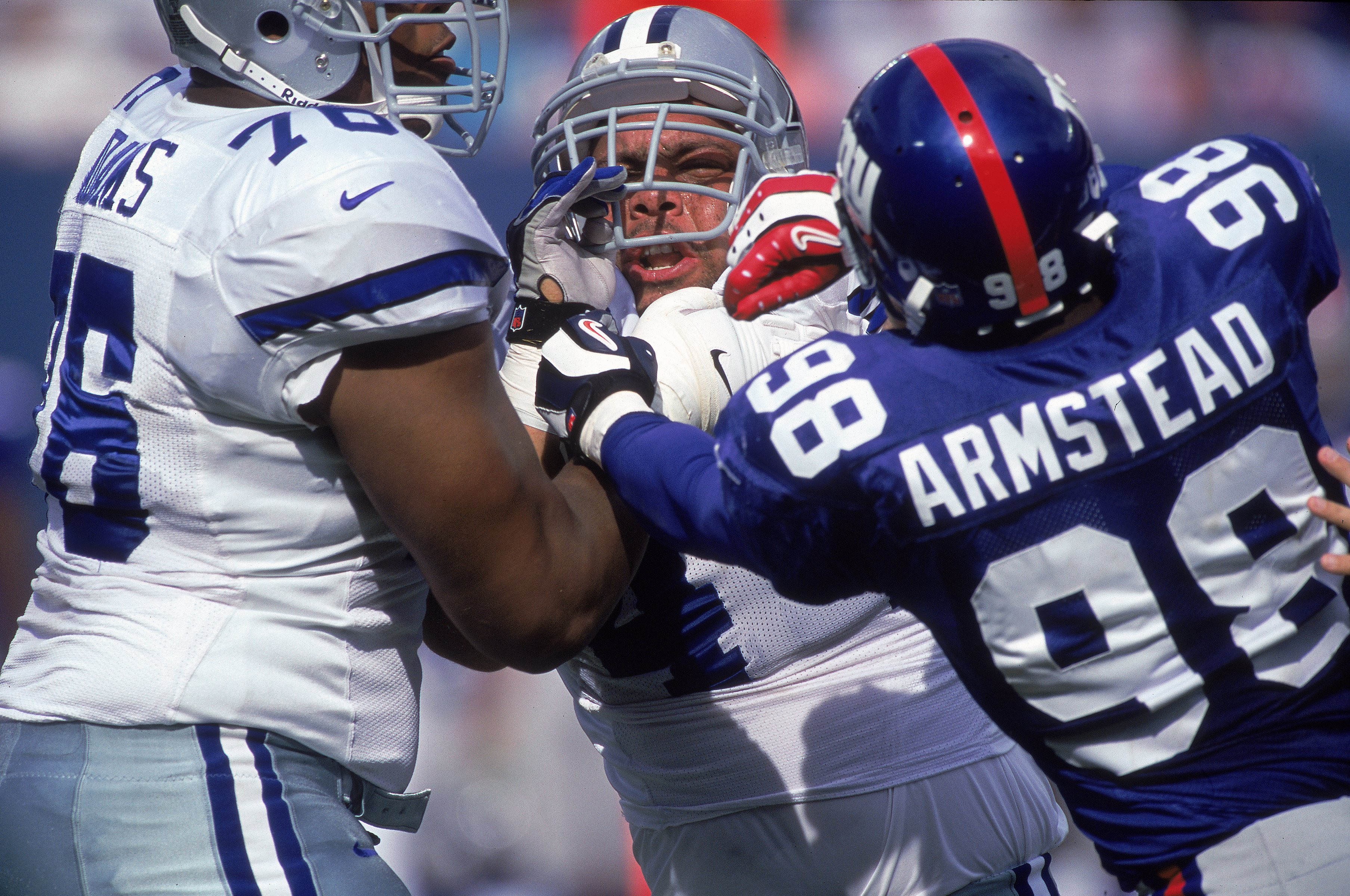 15 Oct 2000:  Robert Thomas #44 and Flozeu Adams #76 of the Dallas Cowboys get into an altercation with Jessie Armstead #99 of the New York Giants during the game at the Giants Stadium in East Rutherford, New Jersey. The Giants defeated the Cowboys 19-14.