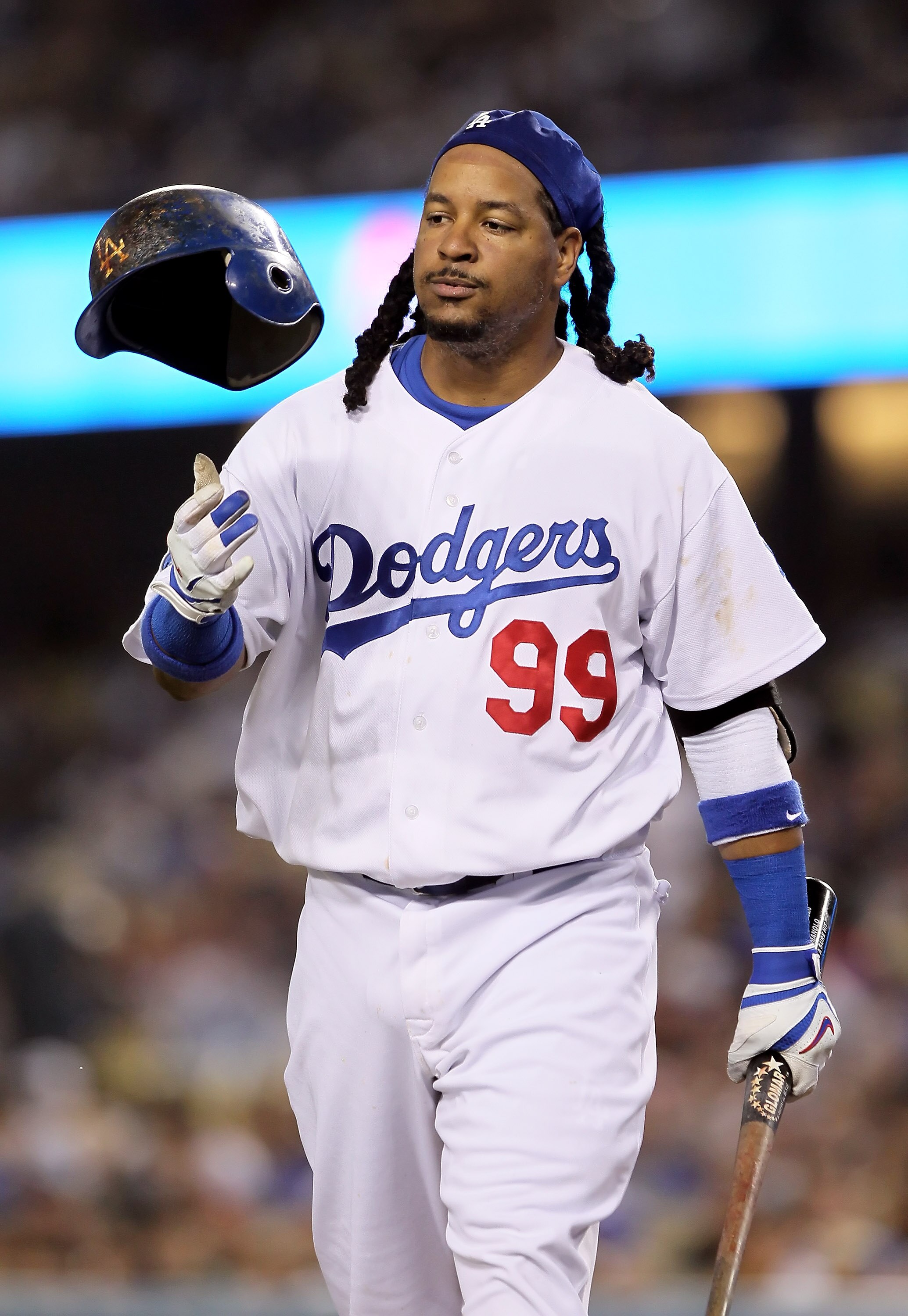 LOS ANGELES, CA - JUNE 04:  Manny Ramirez #99 of the Los Angeles Dodgers tosses his helmet after striking out in the third inning against the Atlanta Braves at Dodger Stadium on June 4, 2010 in Los Angeles, California. The Dodgers defeated the Braves 5-4.