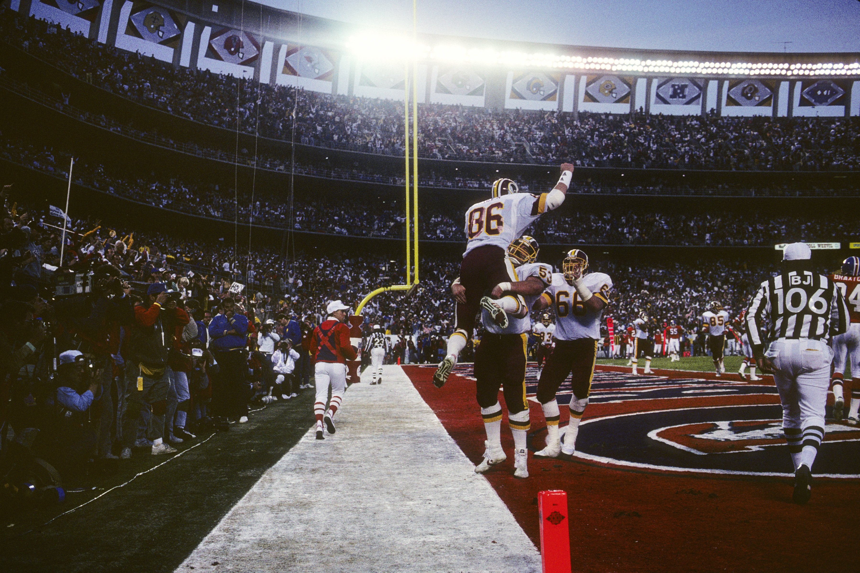 SAN DIEGO - JANUARY 31:  Tight end Clint Didier #86 (T) of the Washington Redskins celebrates with teammate Jeff Bostic #53 (B) after scoring a touchdown during Super Bowl XXII against the Denver Broncos at Jack Murphy Stadium on January 31, 1988 in San D