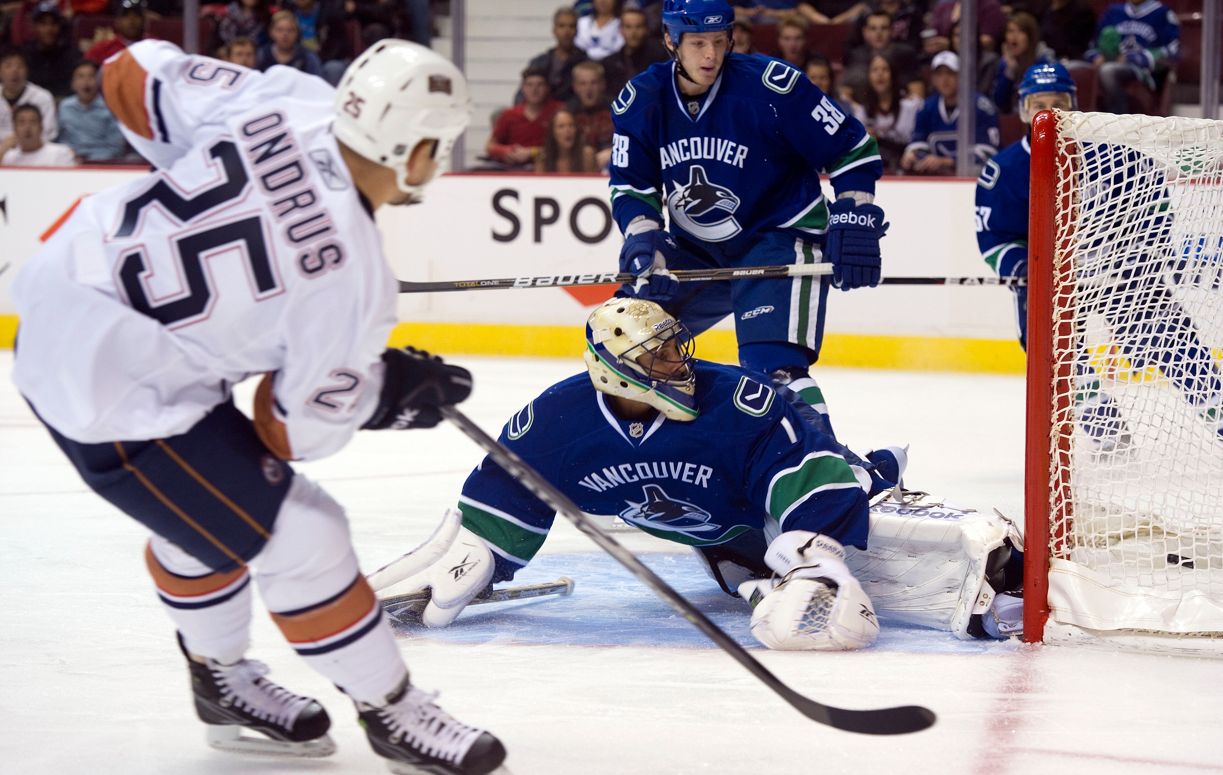VANCOUVER, CANADA - SEPTEMBER 22:  Ben Ondurus #25 of the Edmonton Oilers fires the puck past goalie Roberto Luongo #1 of the Vancouver Canucks during the first period in preseason NHL action on September 22, 2010 at Rogers Arena in Vancouver, British Col