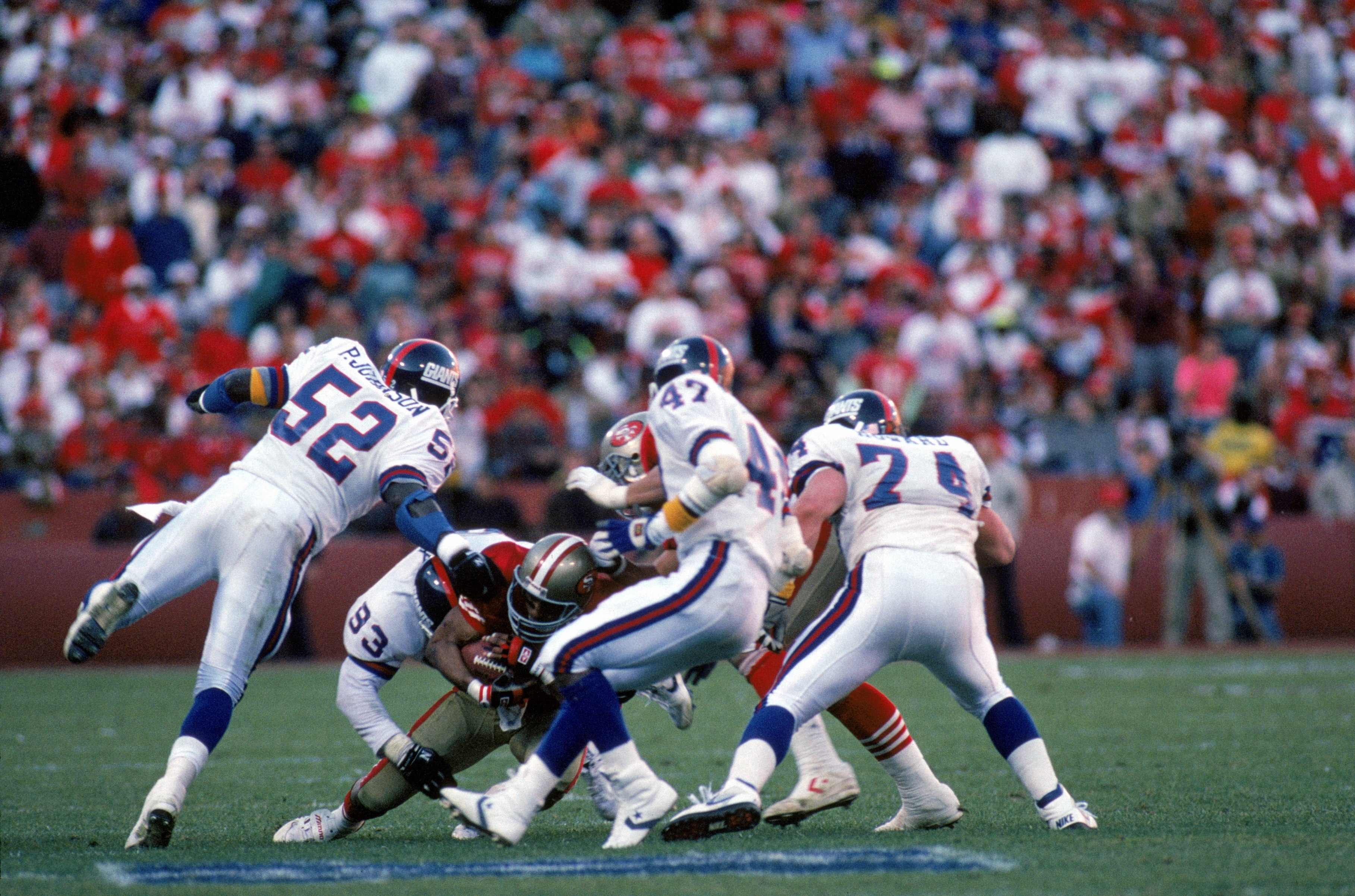SAN FRANCISCO - JANUARY 20:  Linebacker Pepper Johnson #52, defensive end Mike Fox #93 and safety Greg Jackson #47 of the New York Giants team up to tackle San Francisco 49ers running back Roger Craig #33 during the 1990 NFC Championship Game at Candlesti