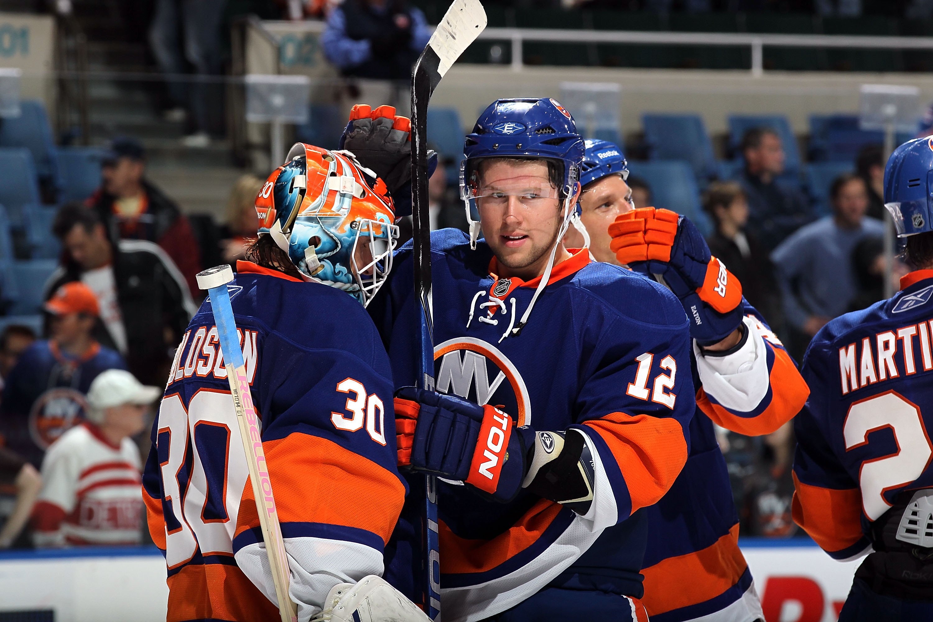 UNIONDALE, NY - OCTOBER 16:  Josh Bailey #12 and Dwayne Roloson #30 of the New York Islanders celebrate against the Colorado Avalanche on October 16, 2010 at Nassau Coliseum in Uniondale, New York.  (Photo by Jim McIsaac/Getty Images)